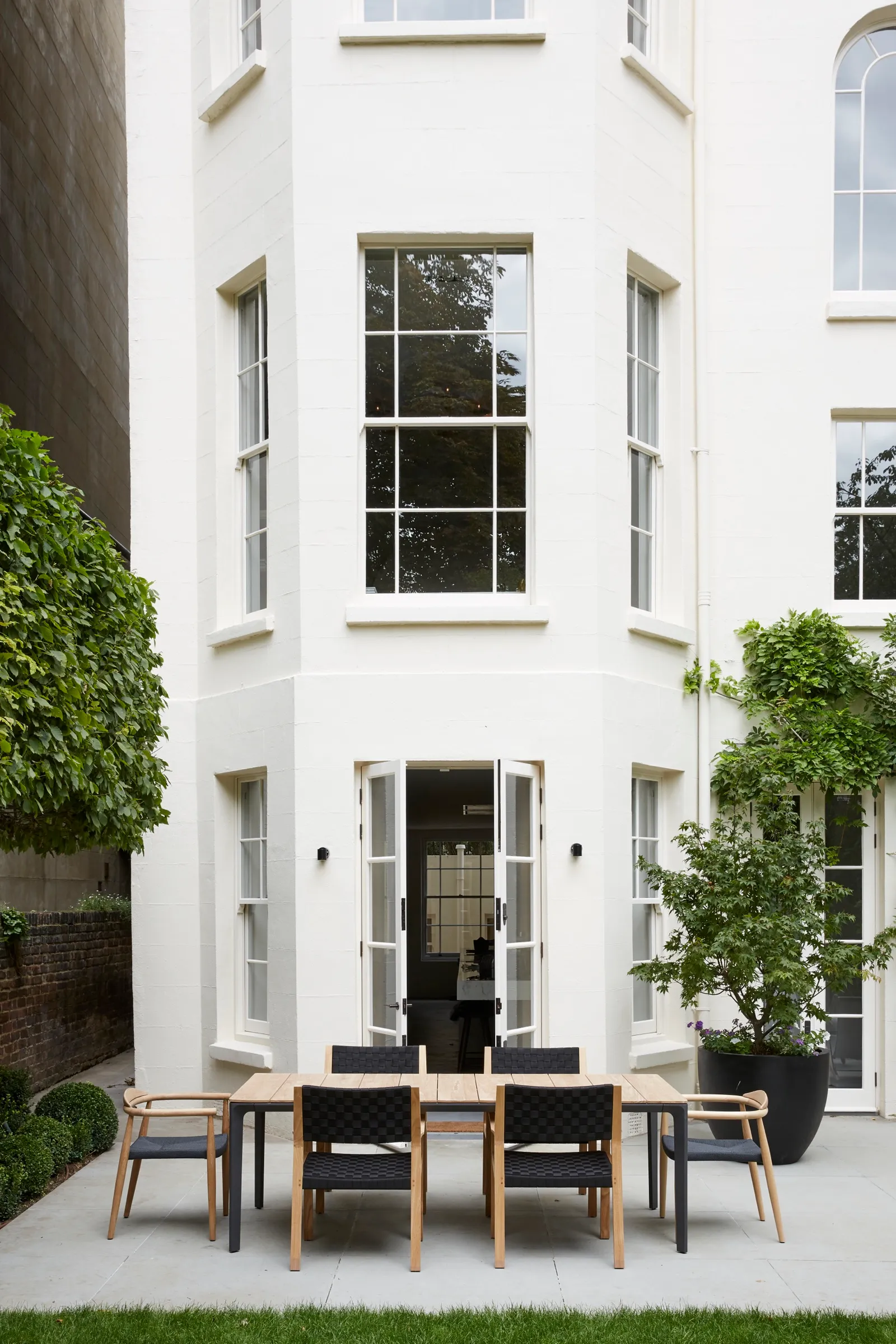 Rear elevation with French doors onto a paved garden
