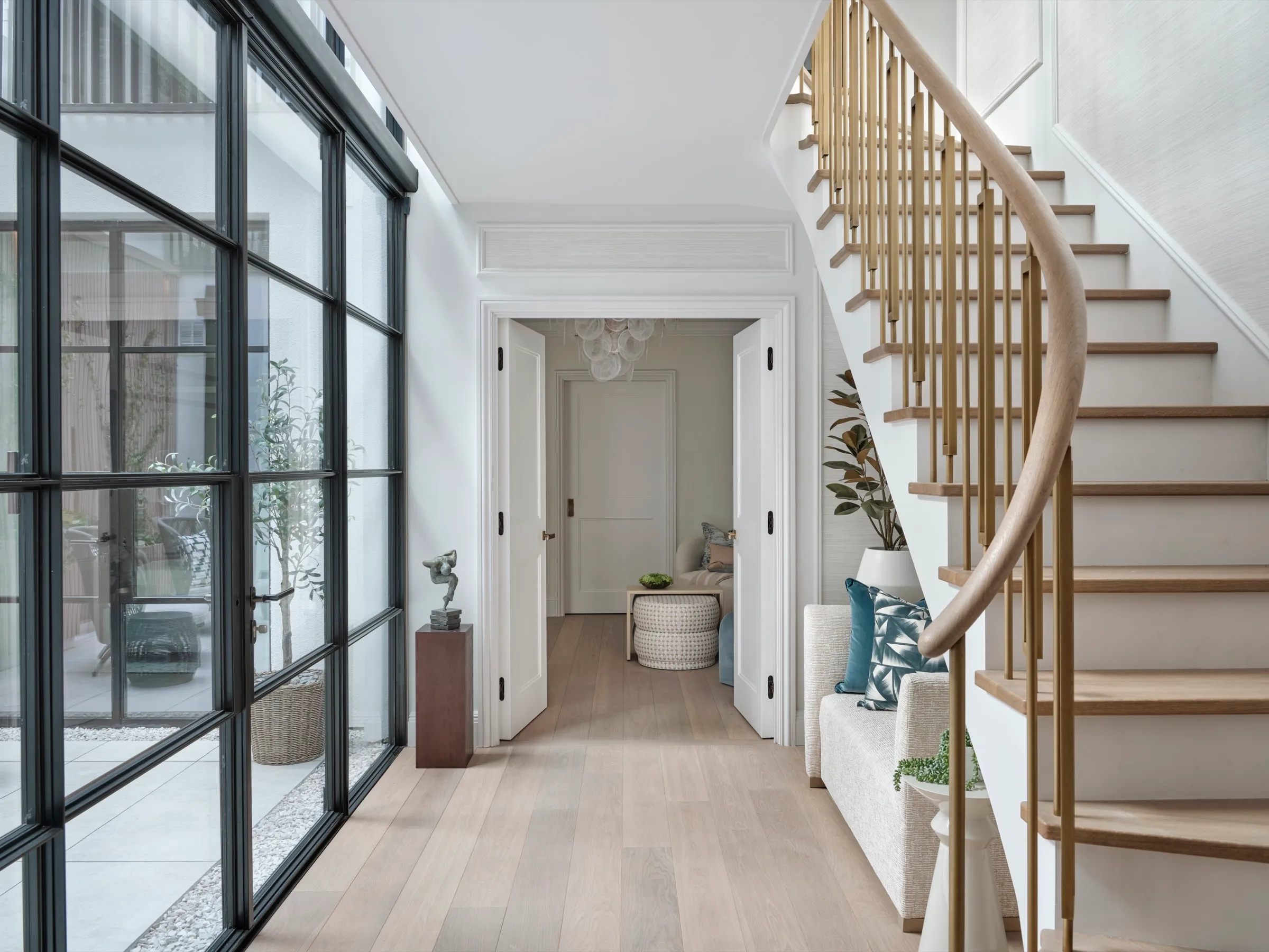 Hallway with steel-framed glazing and curved staircase