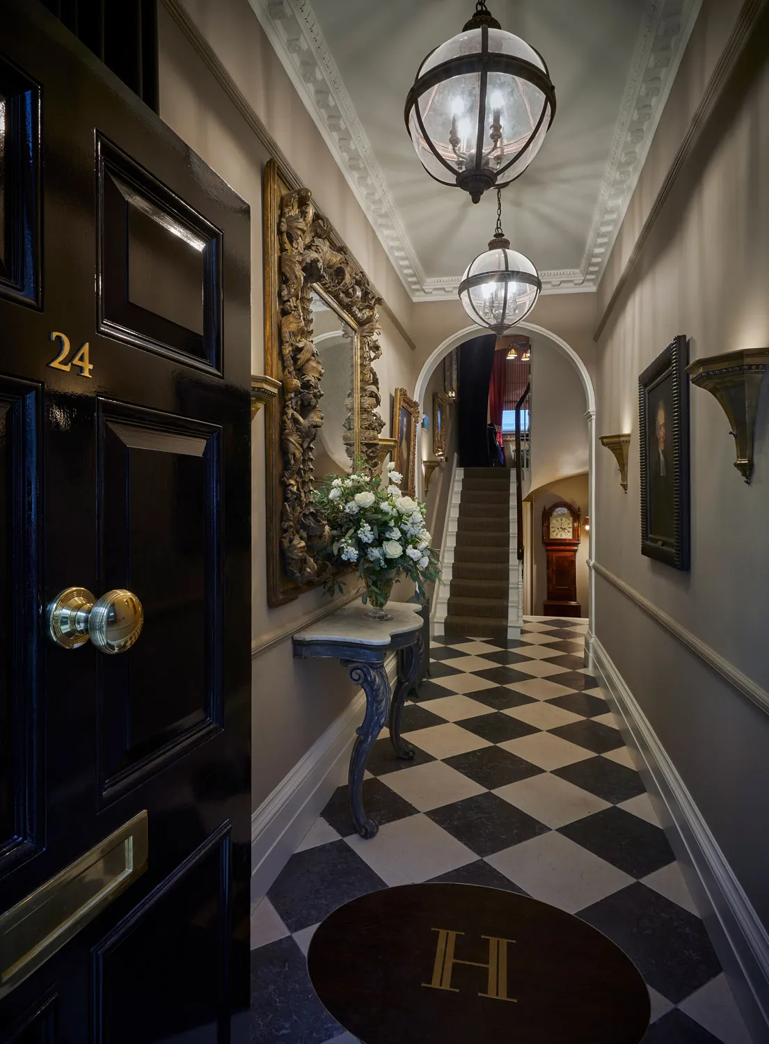 Entrance hall with chequered floor and lantern pendants
