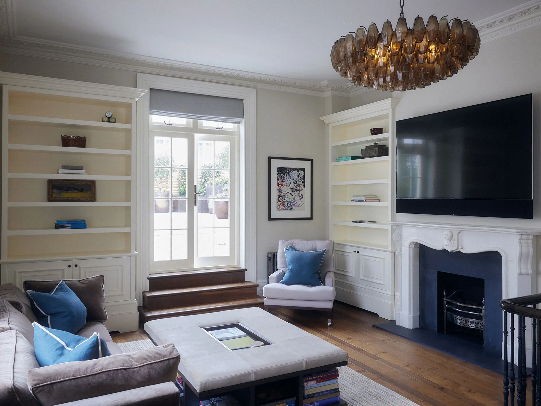Sitting room with fitted shelving and fireplace