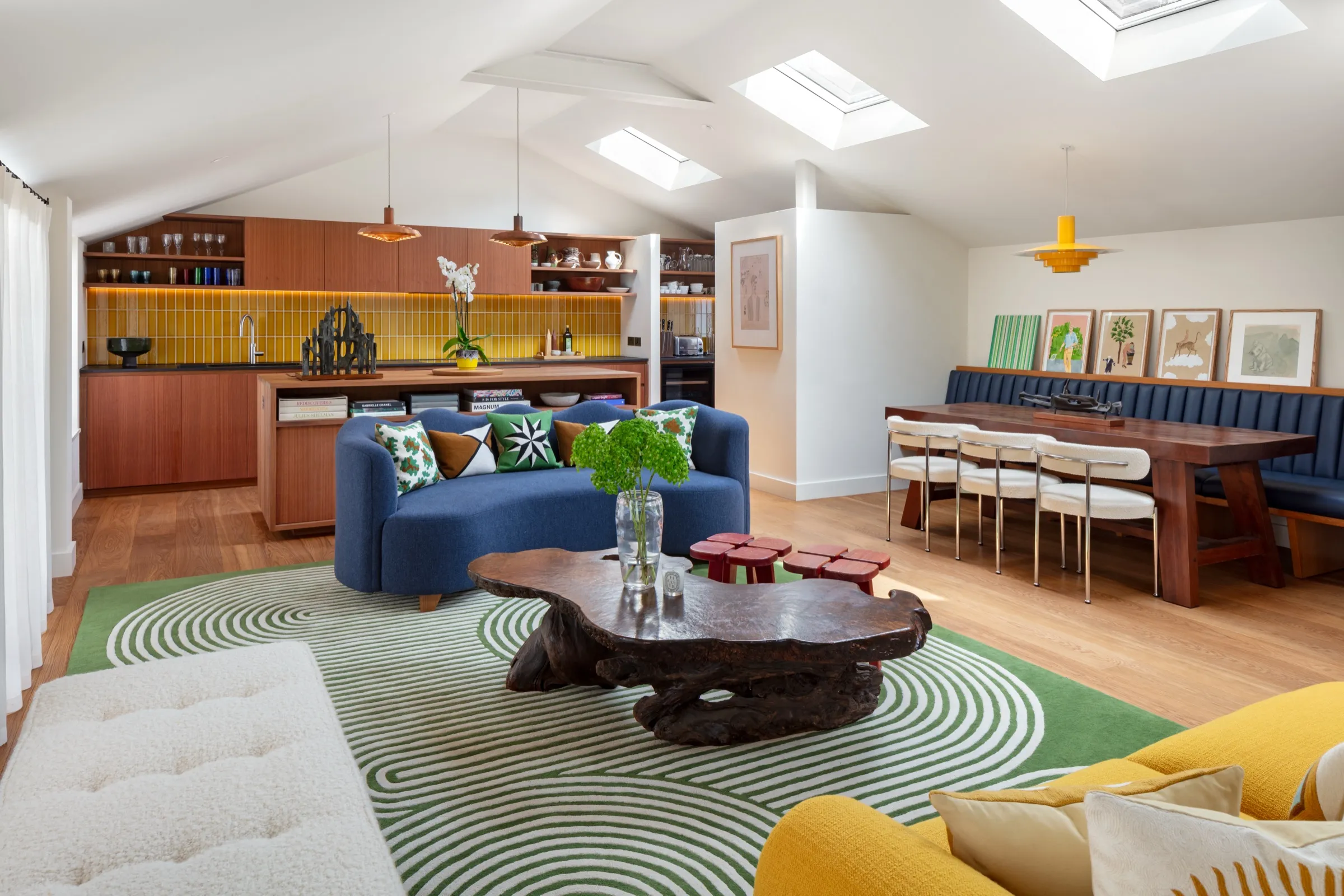Open-plan living and dining room under rooflights