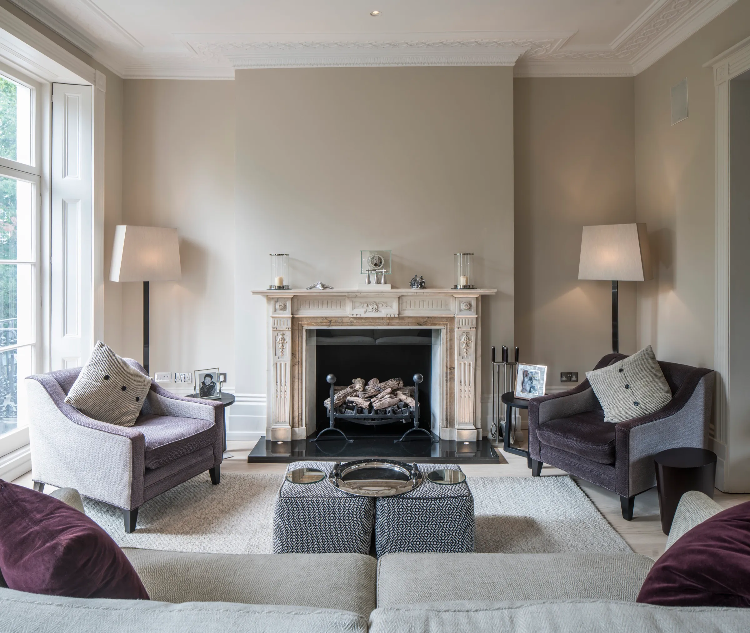 Drawing room with marble fireplace and tall windows