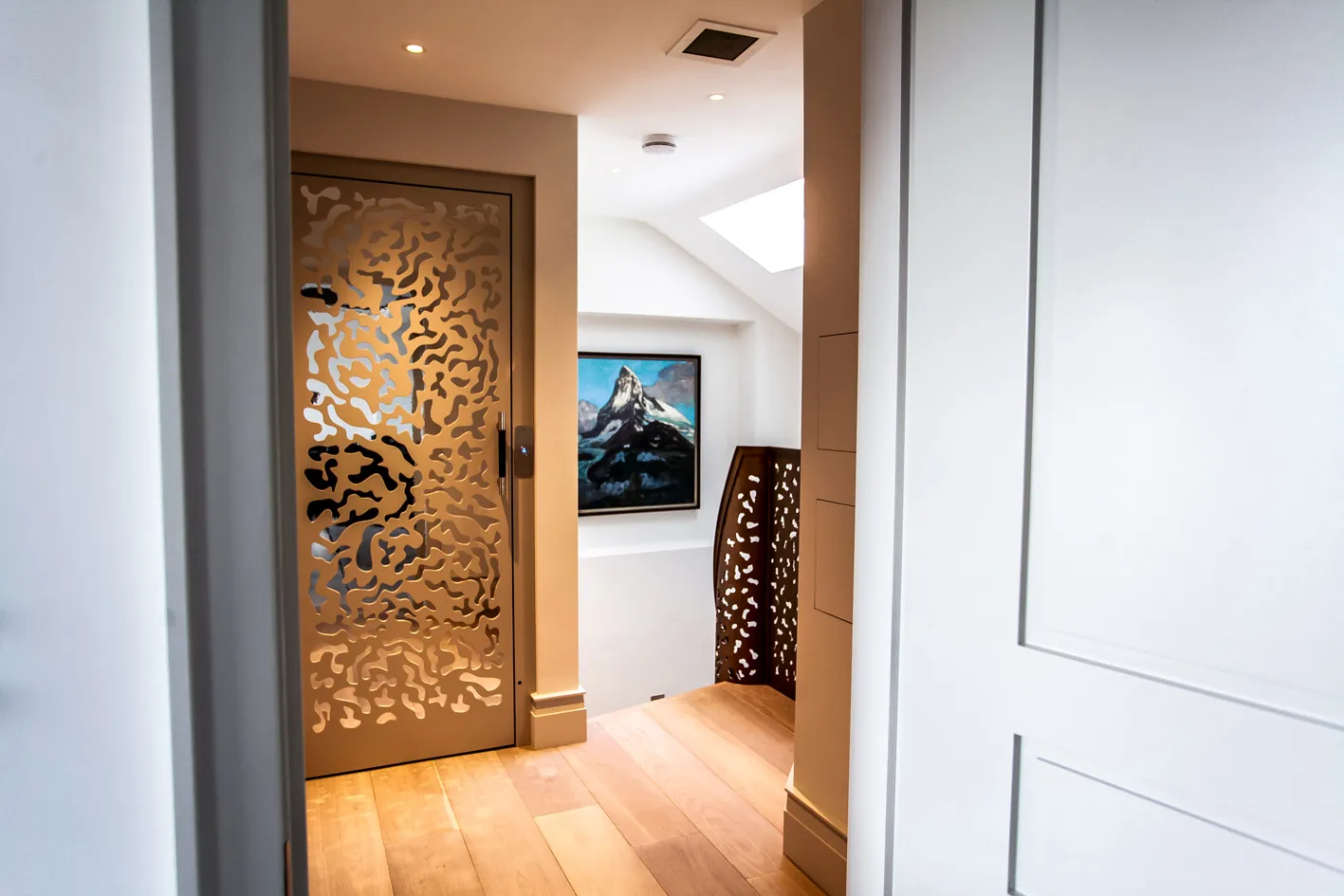 Doorway with laser-cut metal screen door