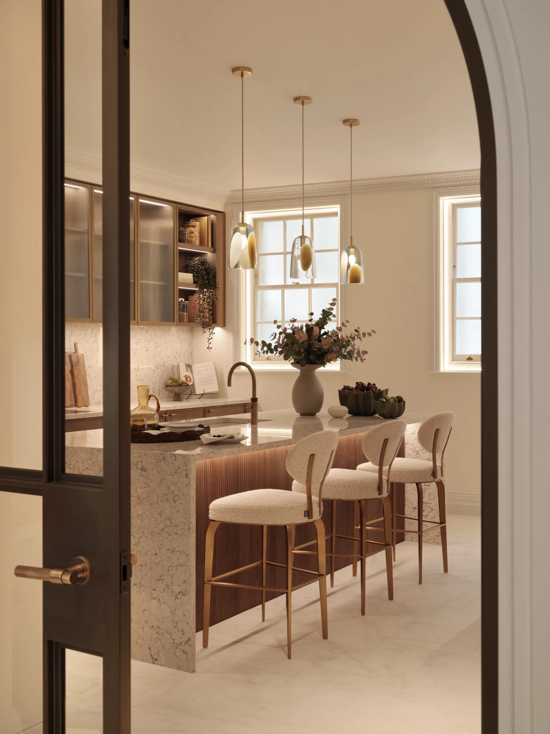 Arched steel-framed door opening into the kitchen