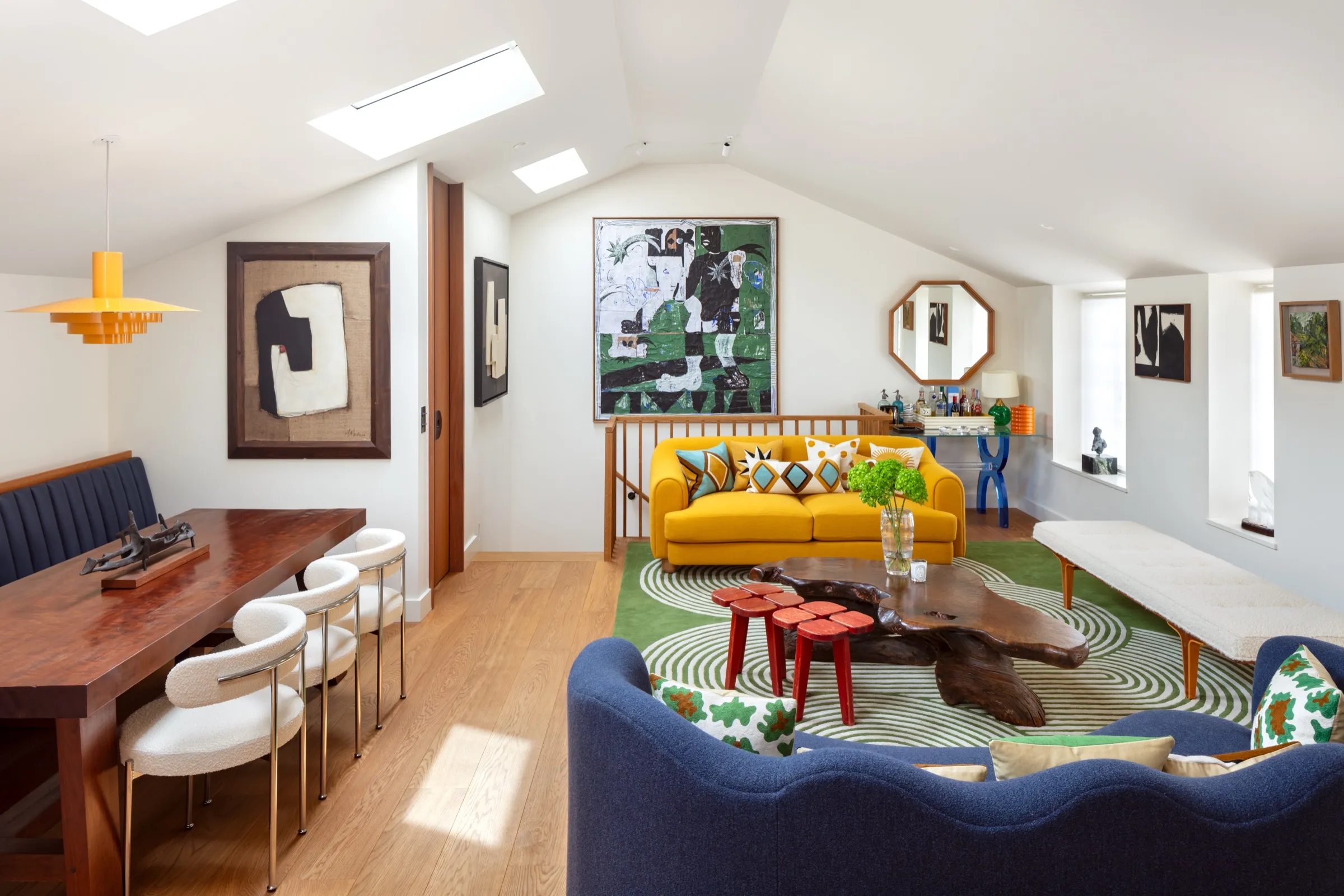 Living area with dining table beneath rooflights