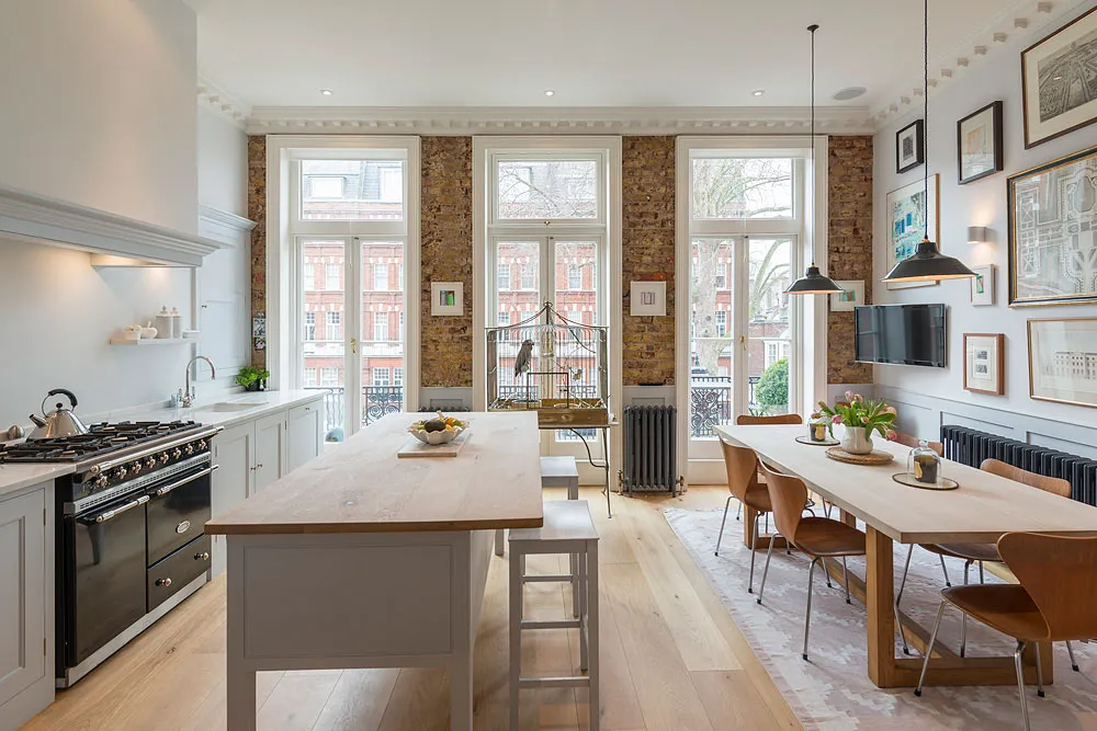 Kitchen with range cooker, island and exposed brick piers