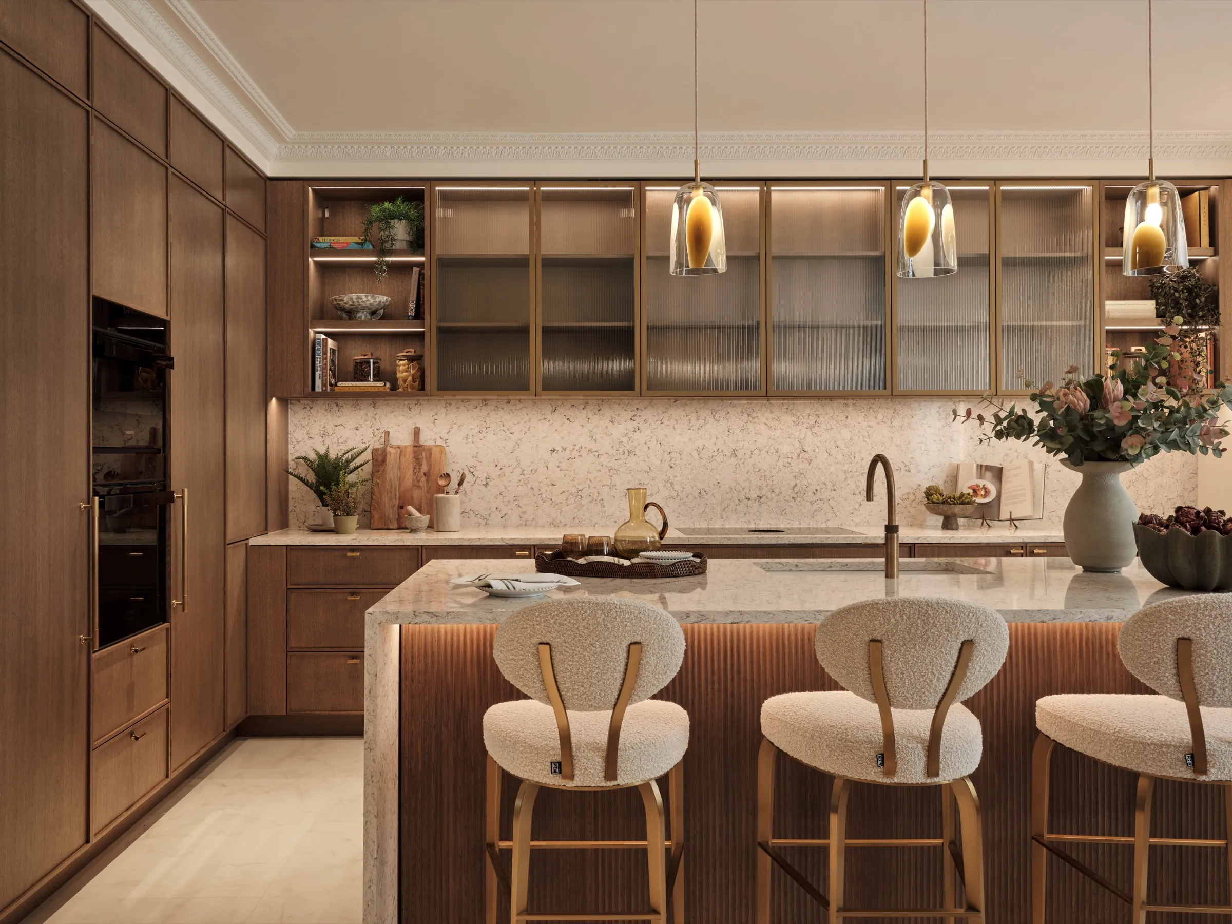 Kitchen with walnut cabinetry, glazed shelving and terrazzo island