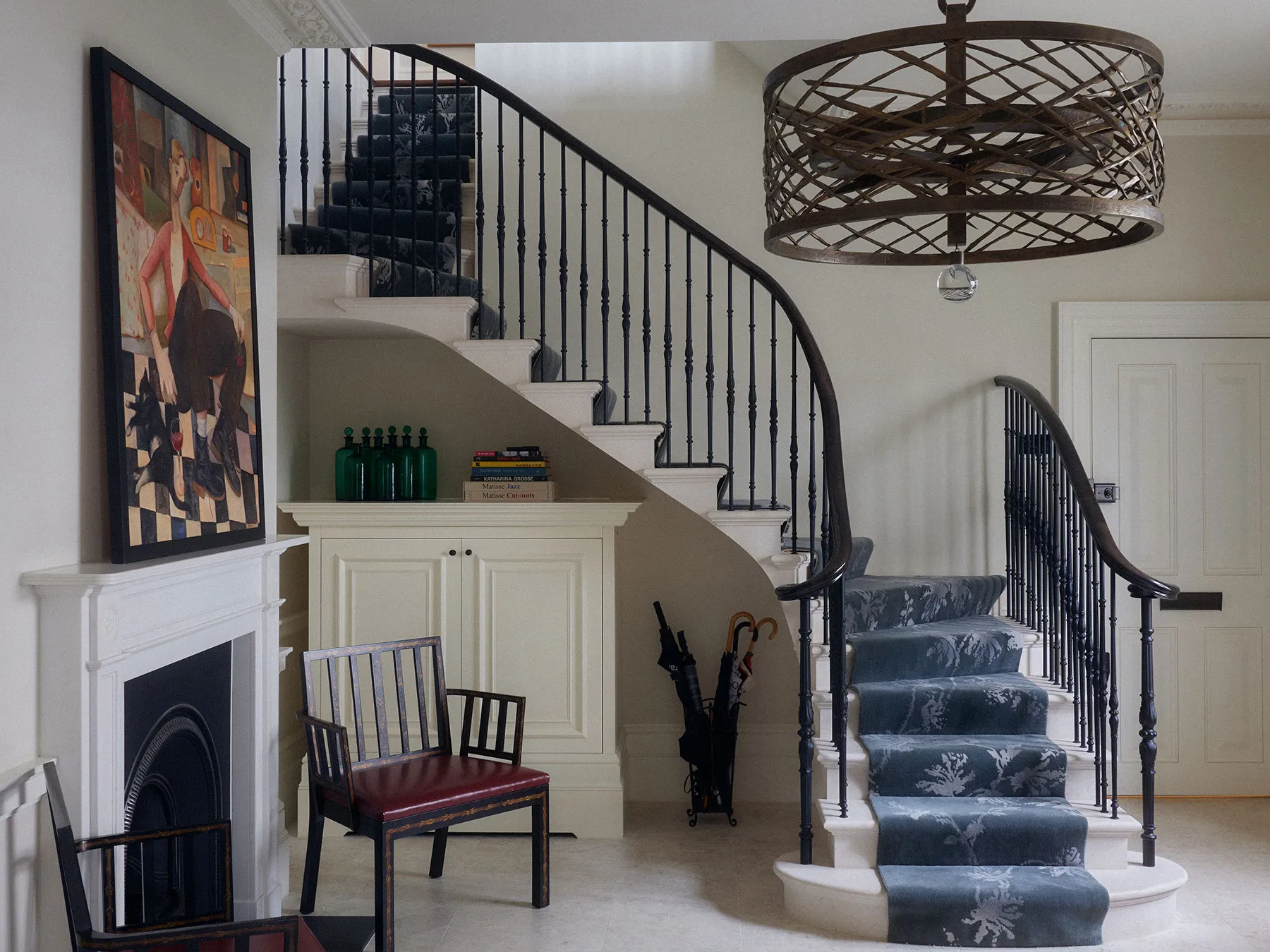 Hall with curved staircase and wrought-iron balustrade