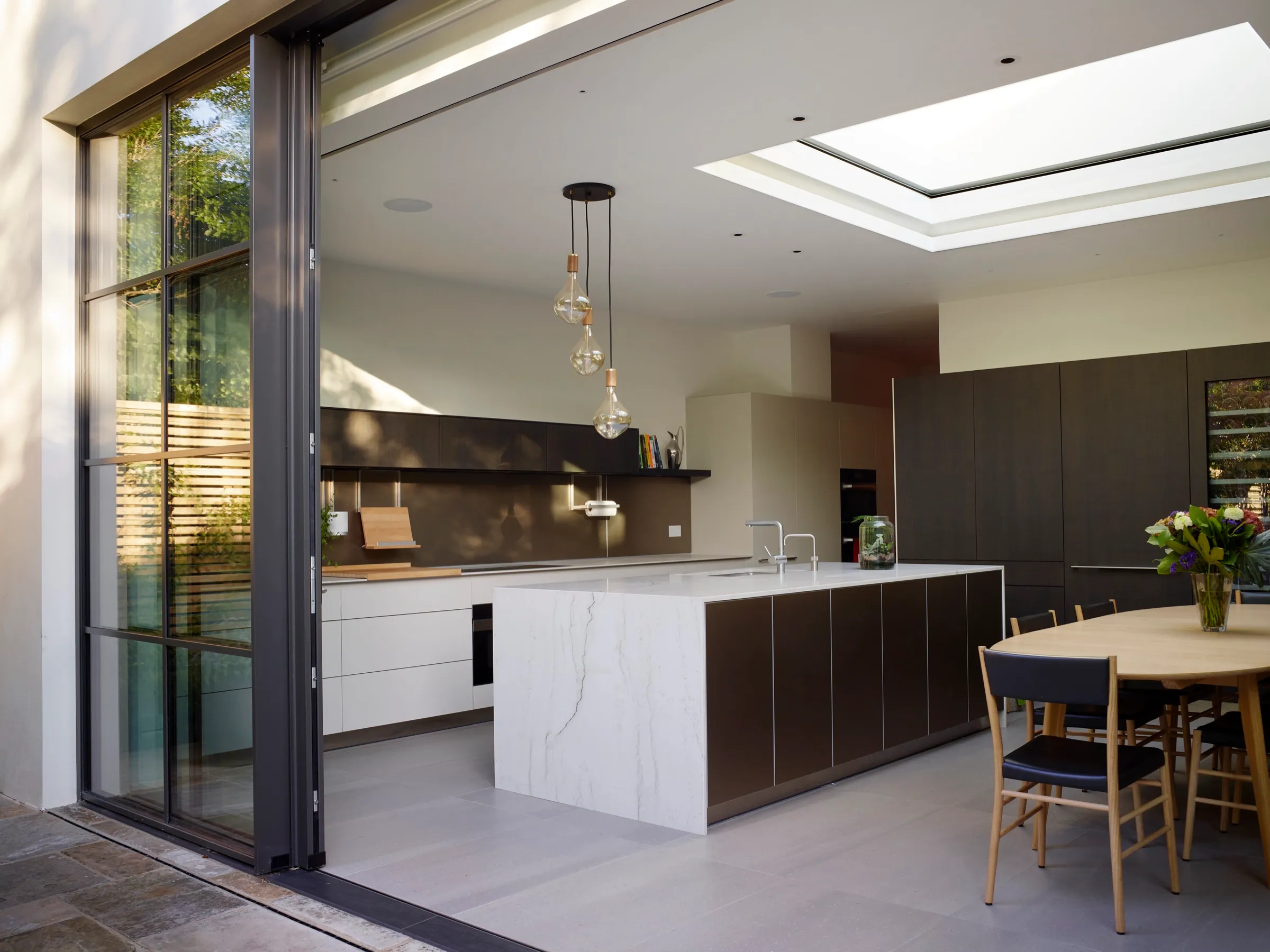 Kitchen in the rear extension with rooflight and sliding glass doors