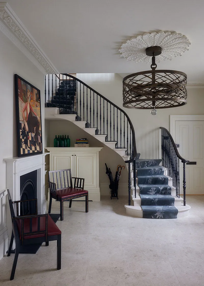 Stair hall with fireplace and curved staircase