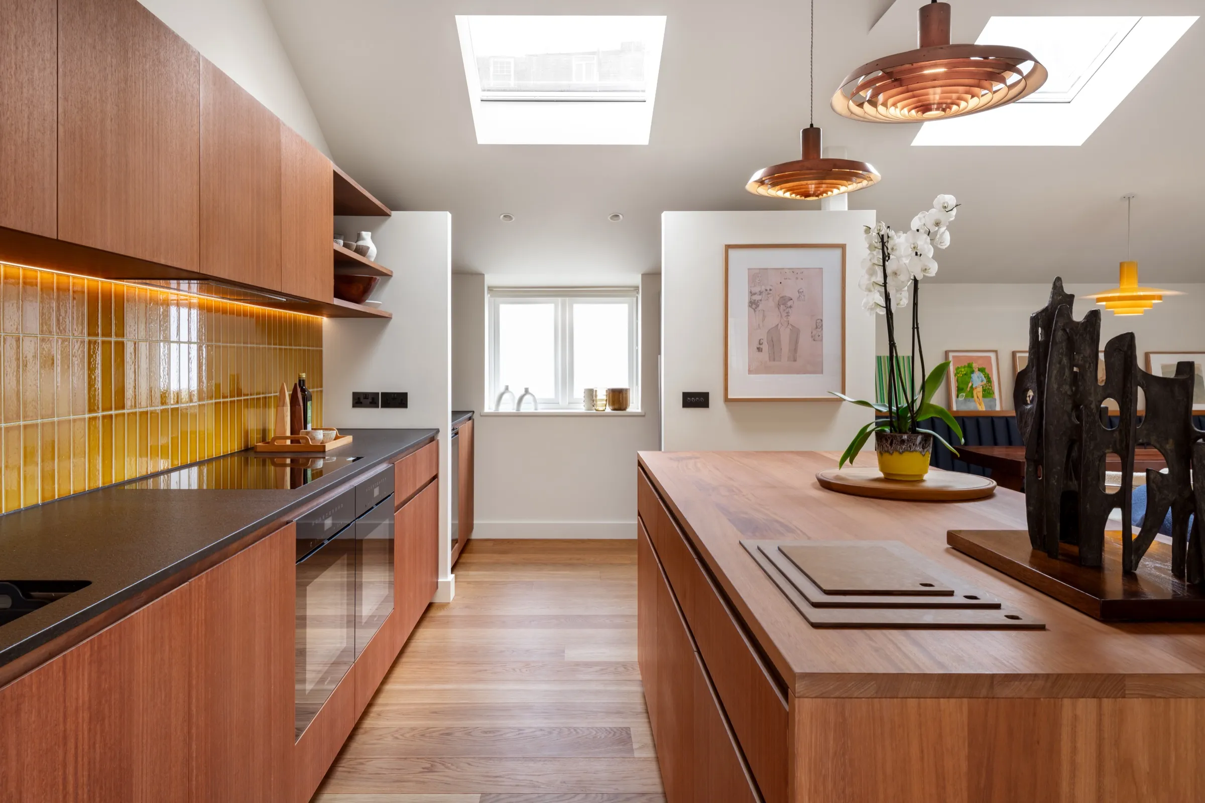 Timber kitchen island beneath rooflights