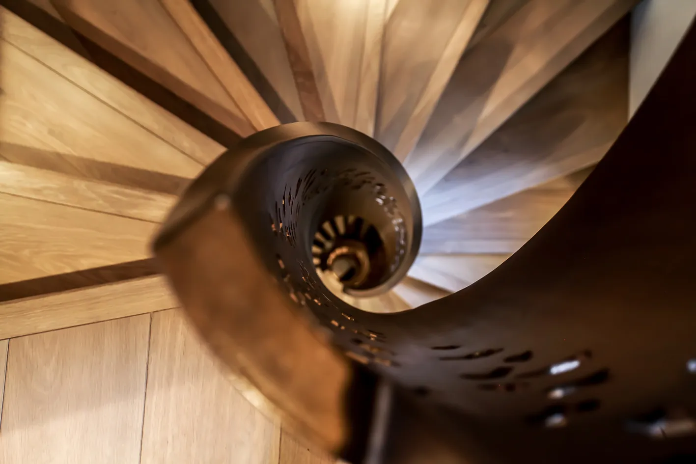 Spiral staircase with sculpted metal handrail