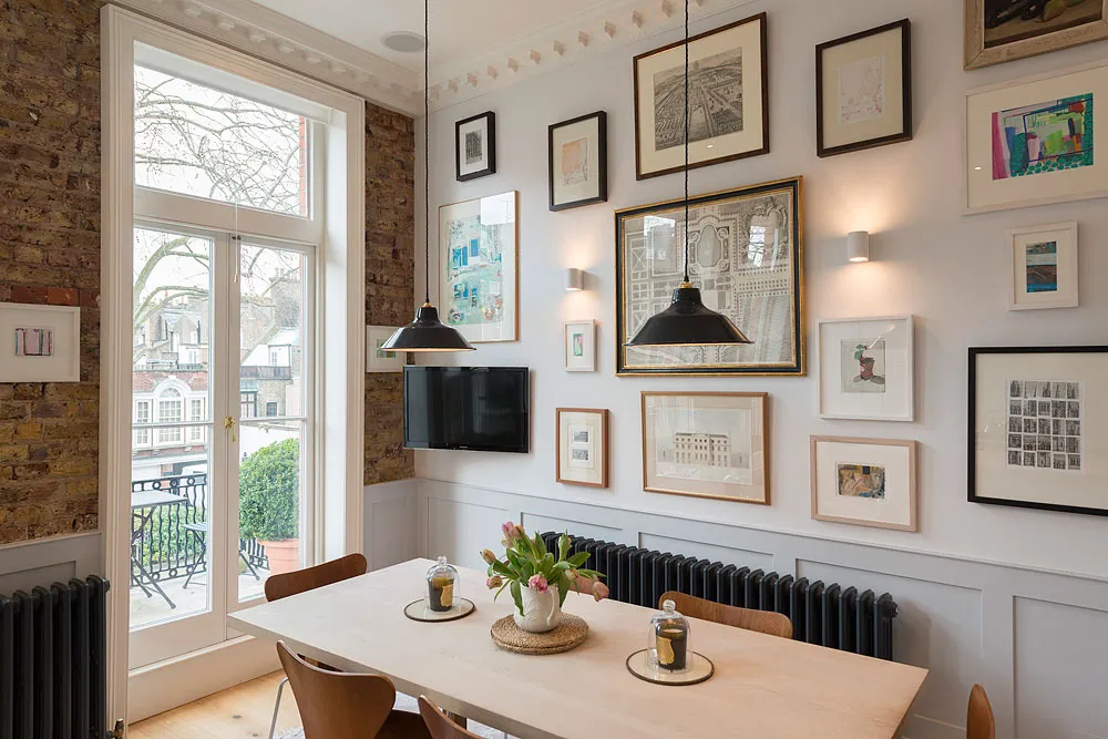 Kitchen dining table beside tall French windows