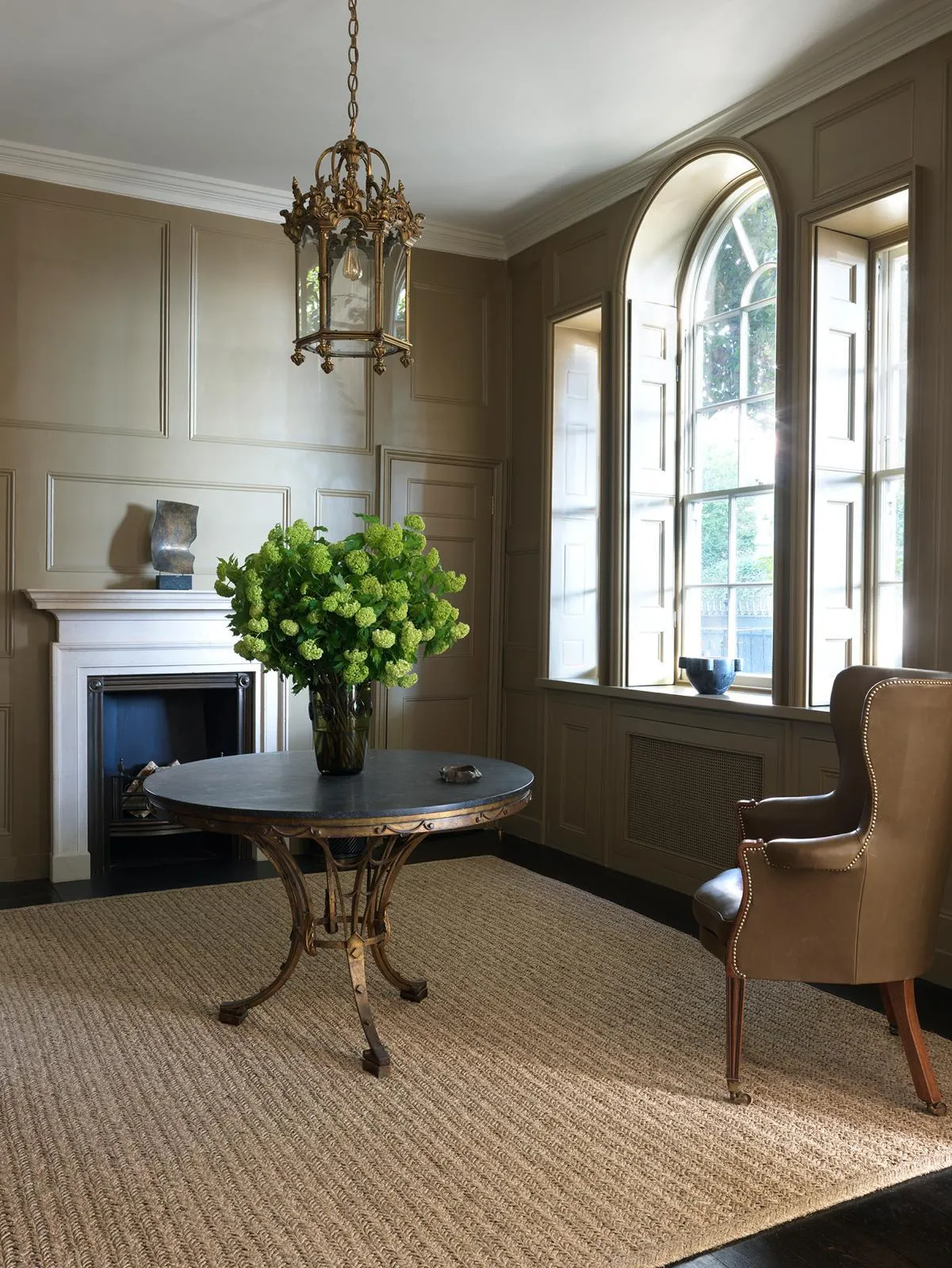 Panelled study with arched windows and fireplace