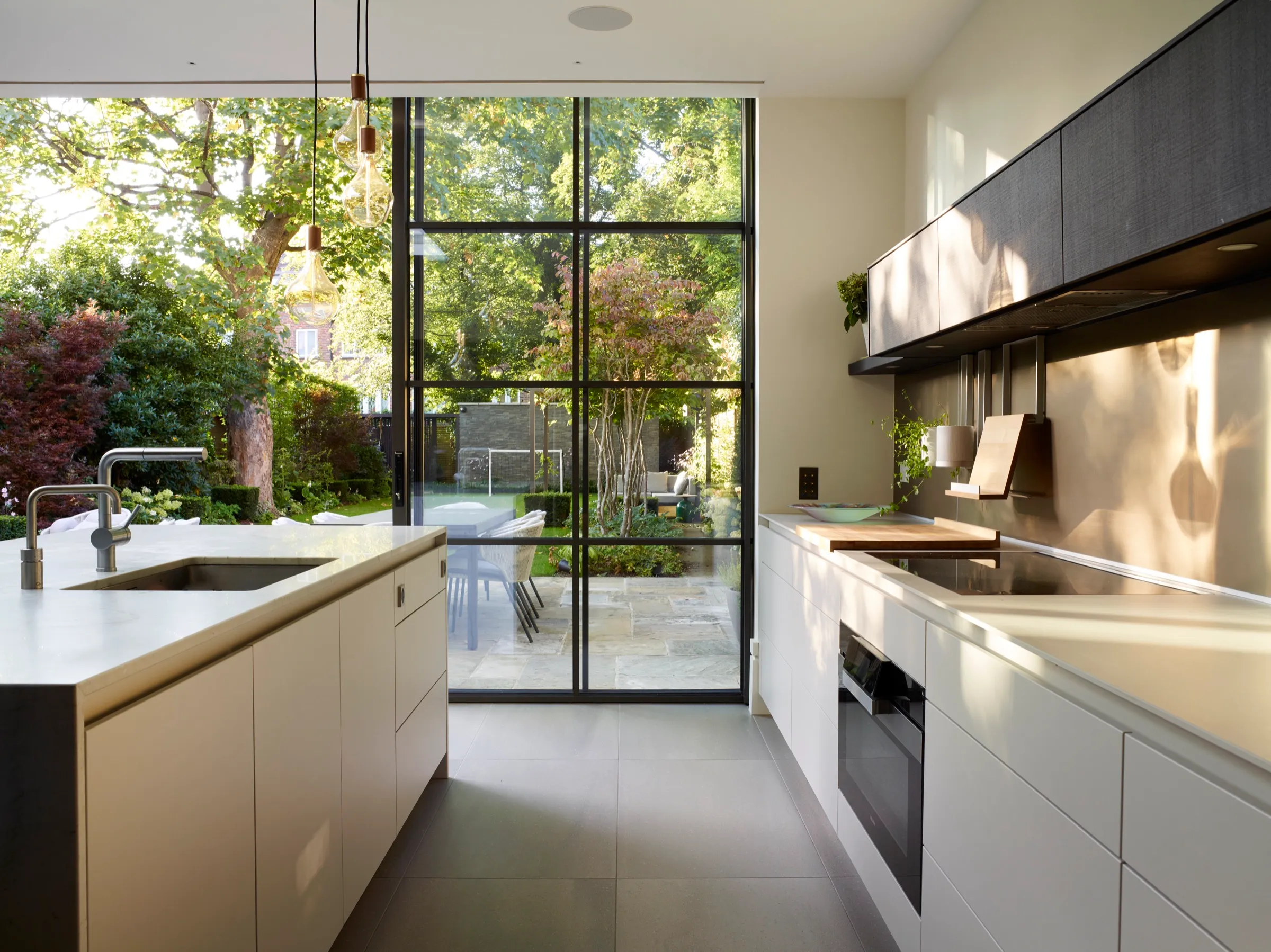 Galley kitchen with full-height steel-framed glazing to the garden