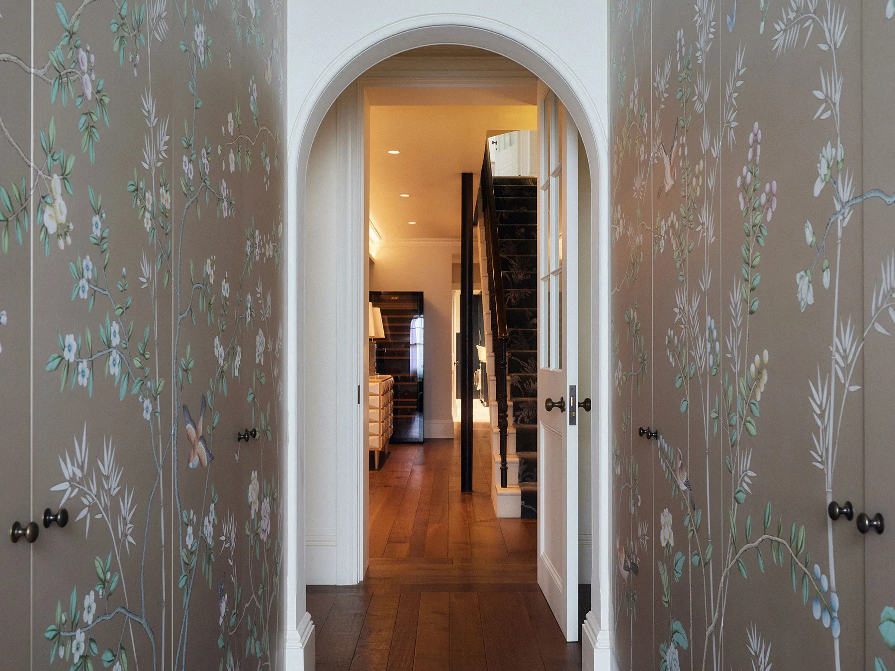 Arched doorway between hand-painted panels