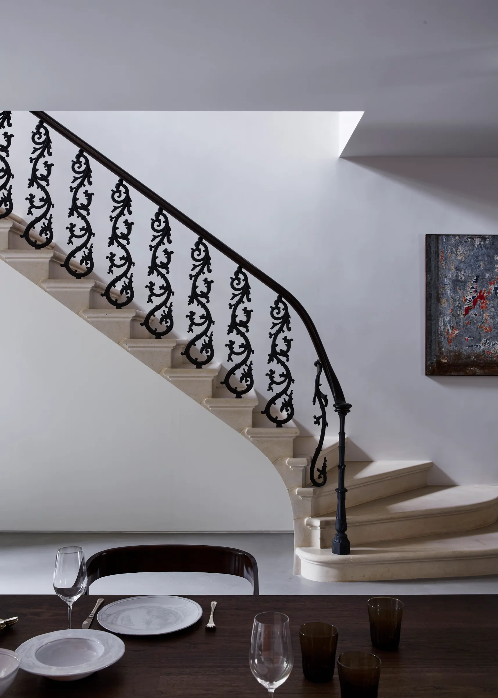 Curved stone staircase with wrought-iron balustrade