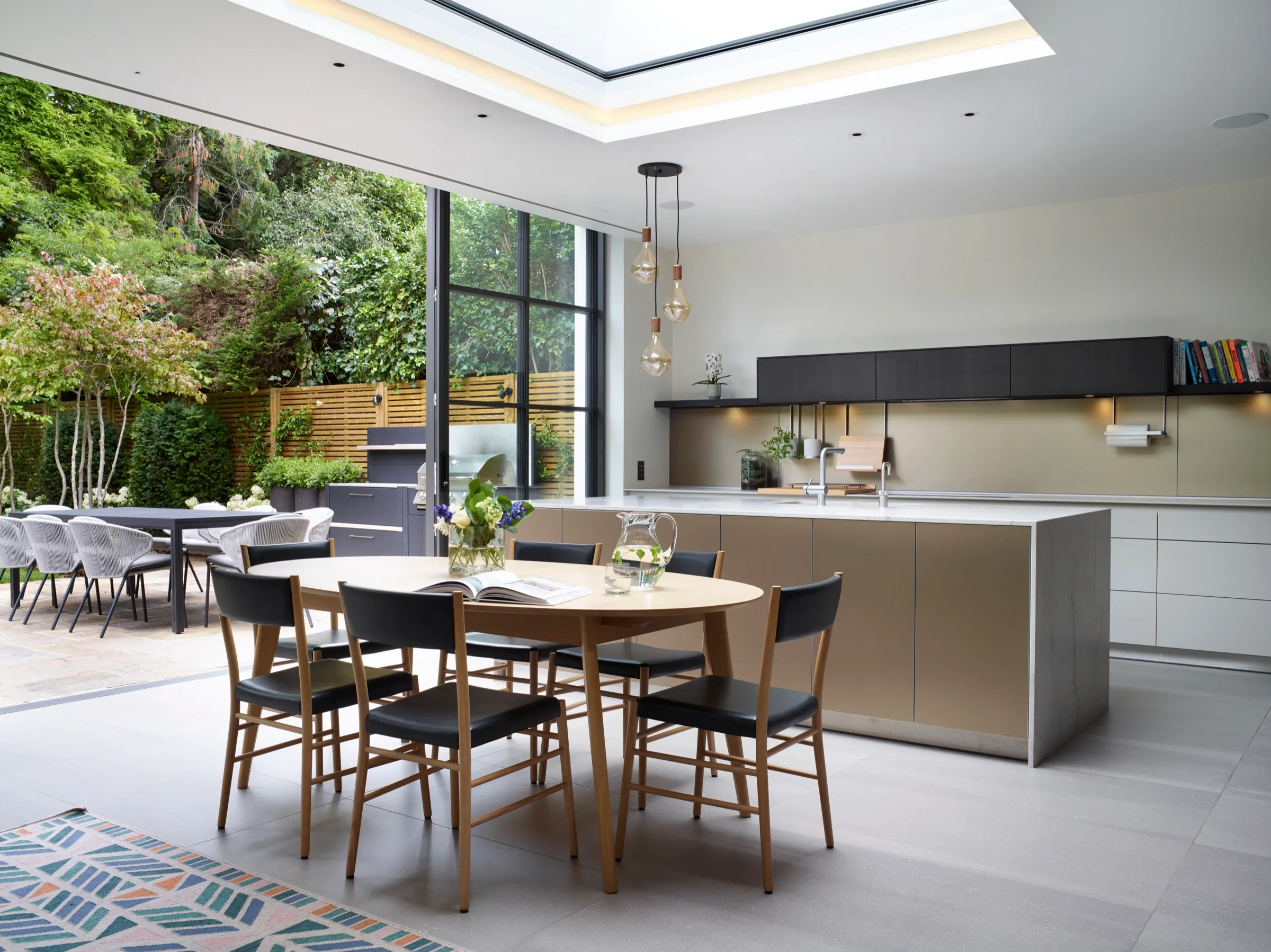 Kitchen and dining area beneath a large rooflight