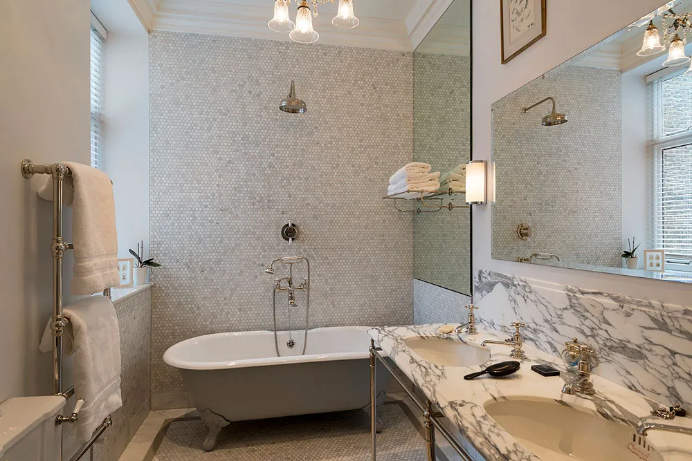 Bathroom with roll-top bath and marble vanity