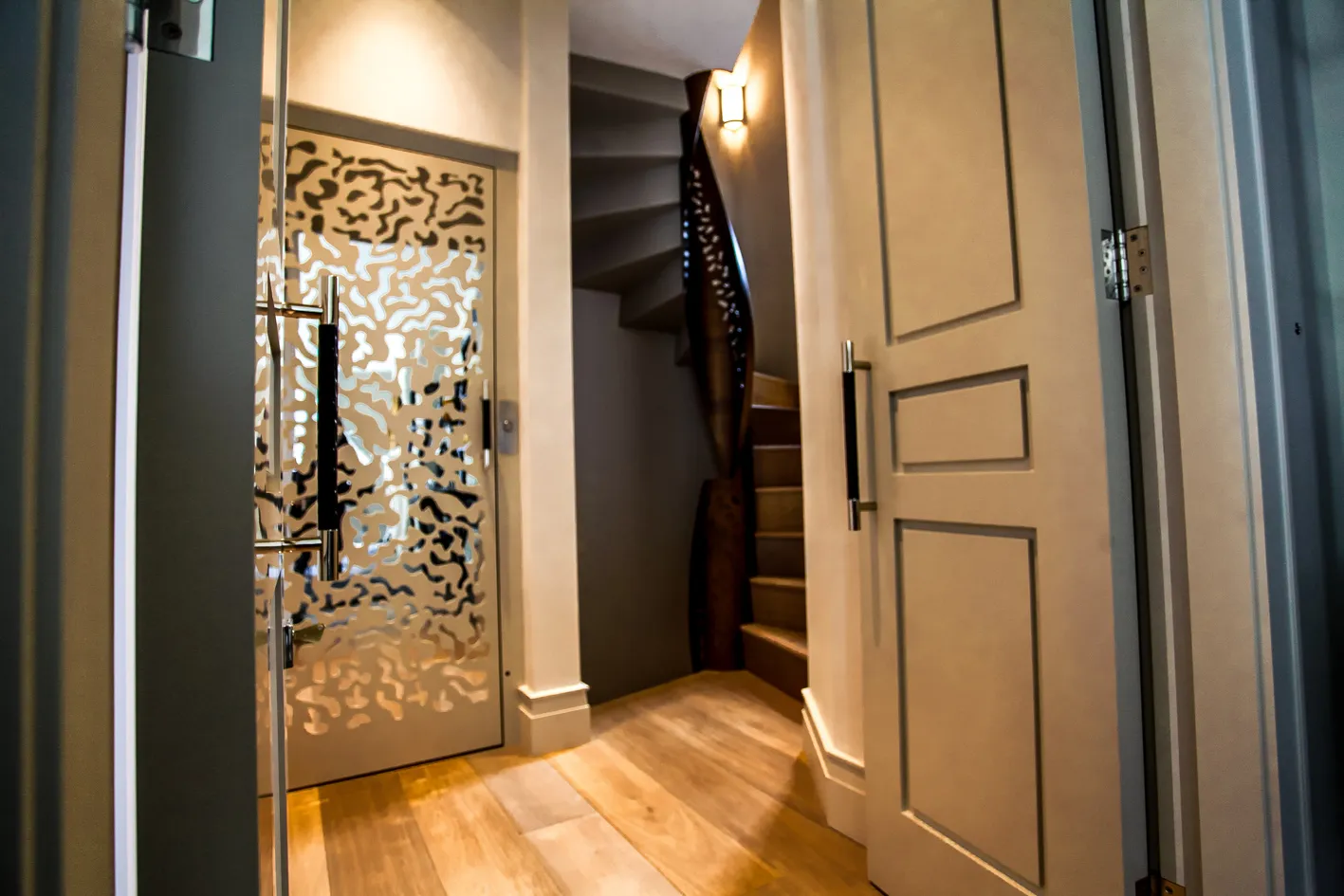 Laser-cut screen door beside the staircase