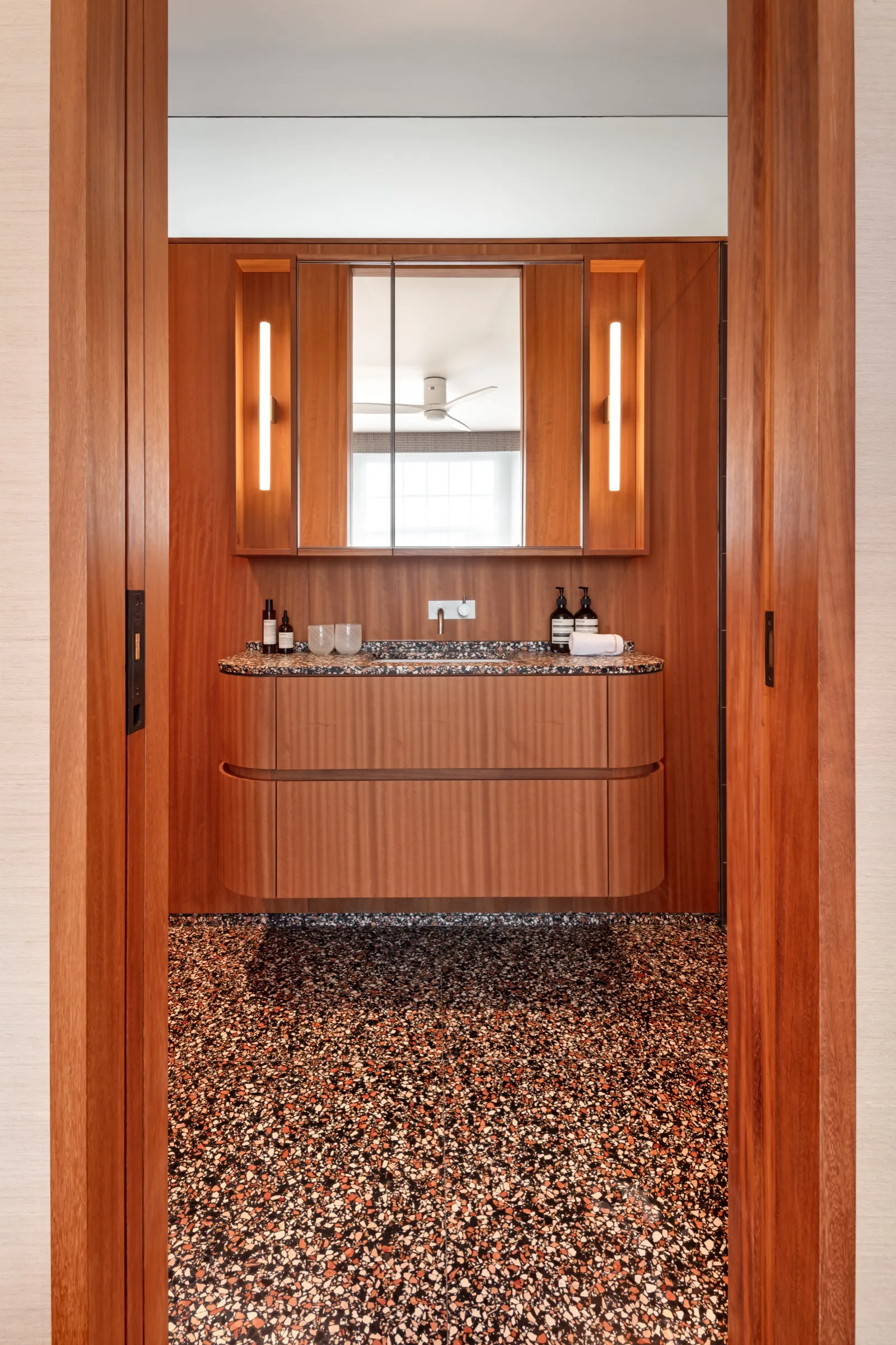 Timber-panelled bathroom with a terrazzo floor