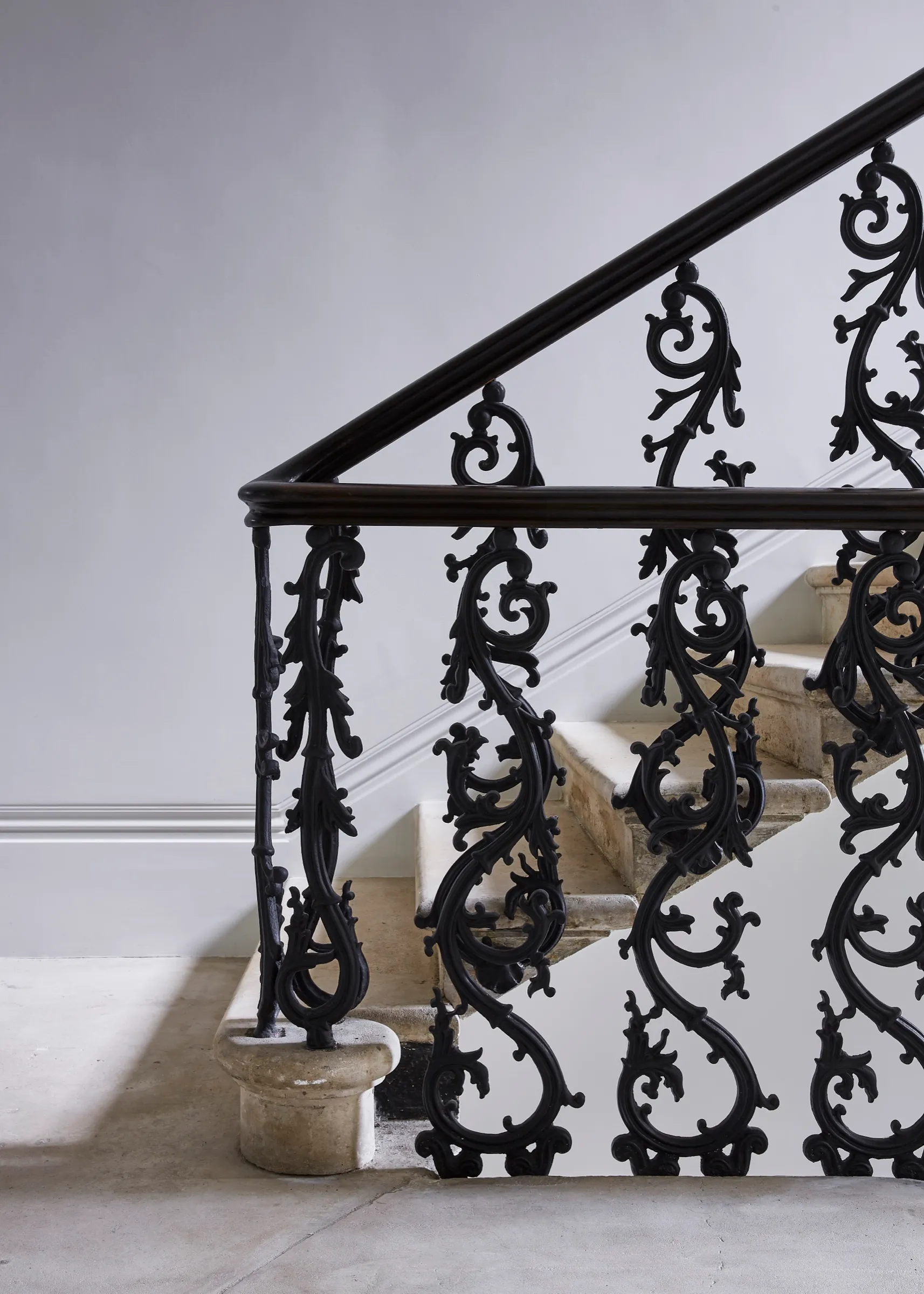 Ornate wrought-iron balustrade on stone stairs