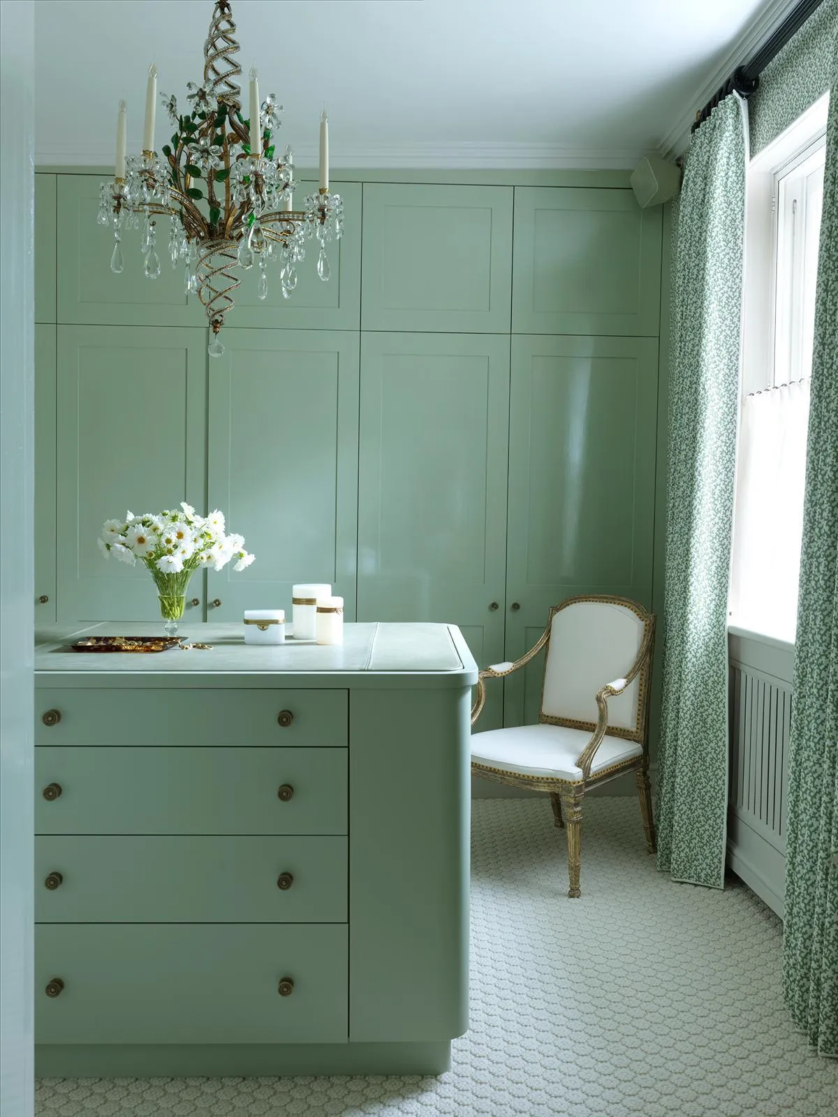 Dressing room with painted green panelling and cabinetry