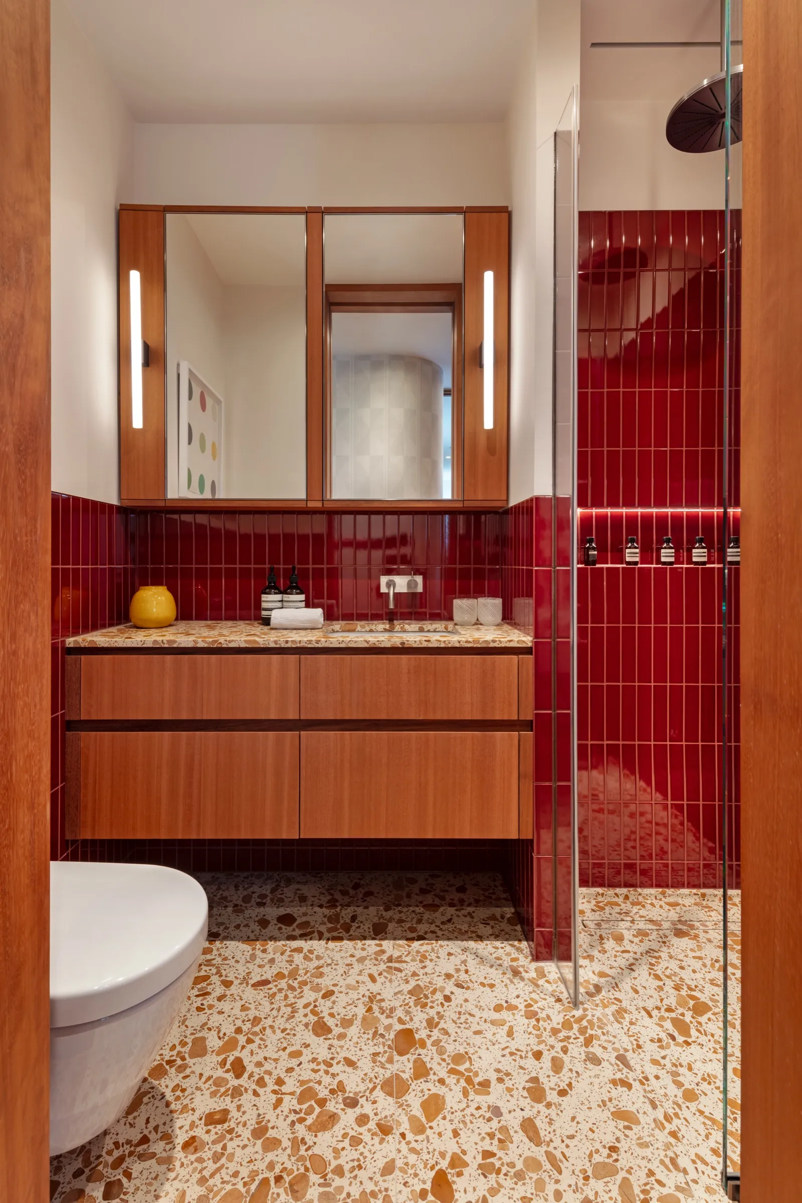 Shower room with red glazed tiles and timber vanity