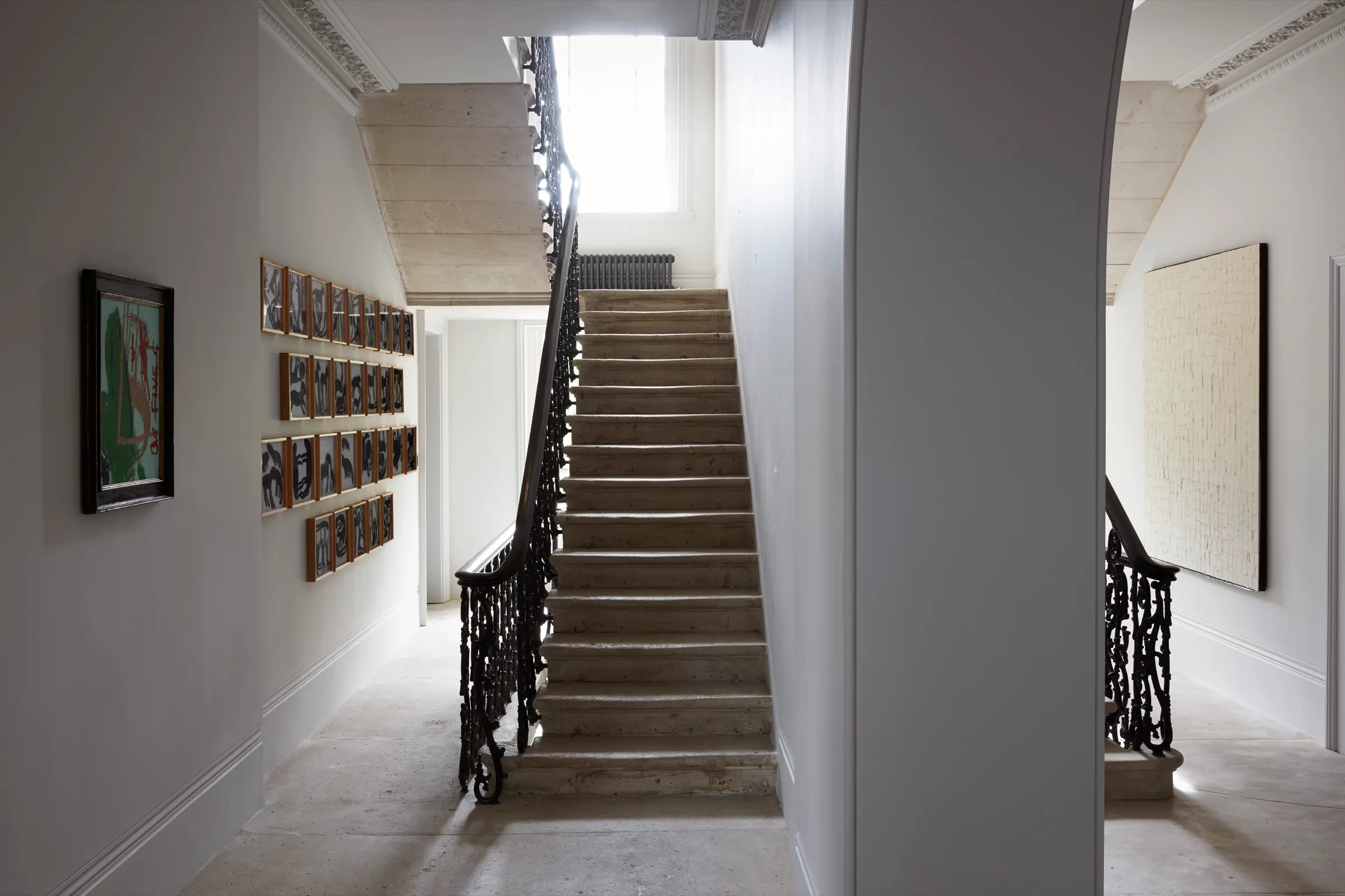 Stone staircase with iron balustrade in the stair hall