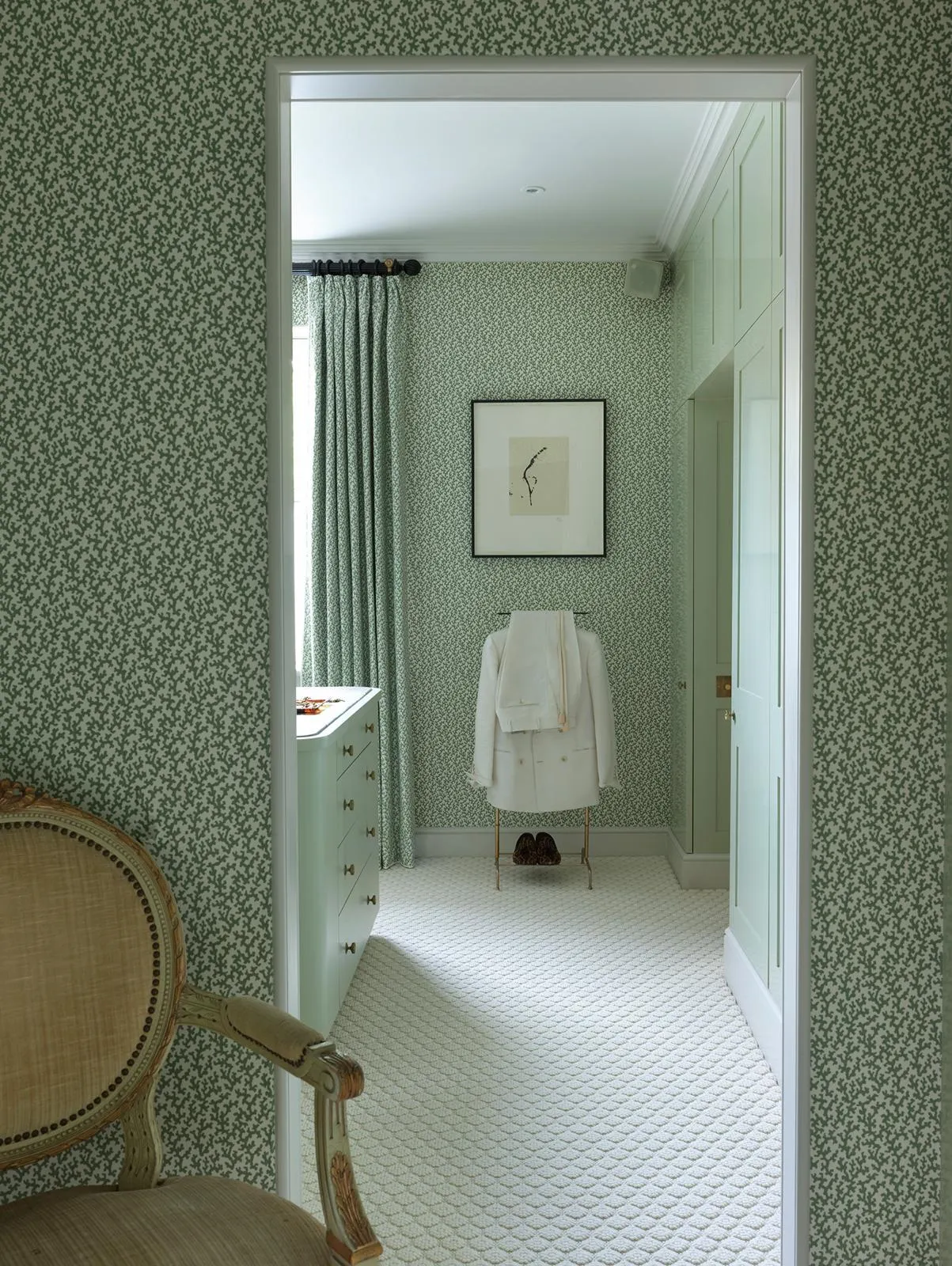 Green panelled bathroom seen through a doorway