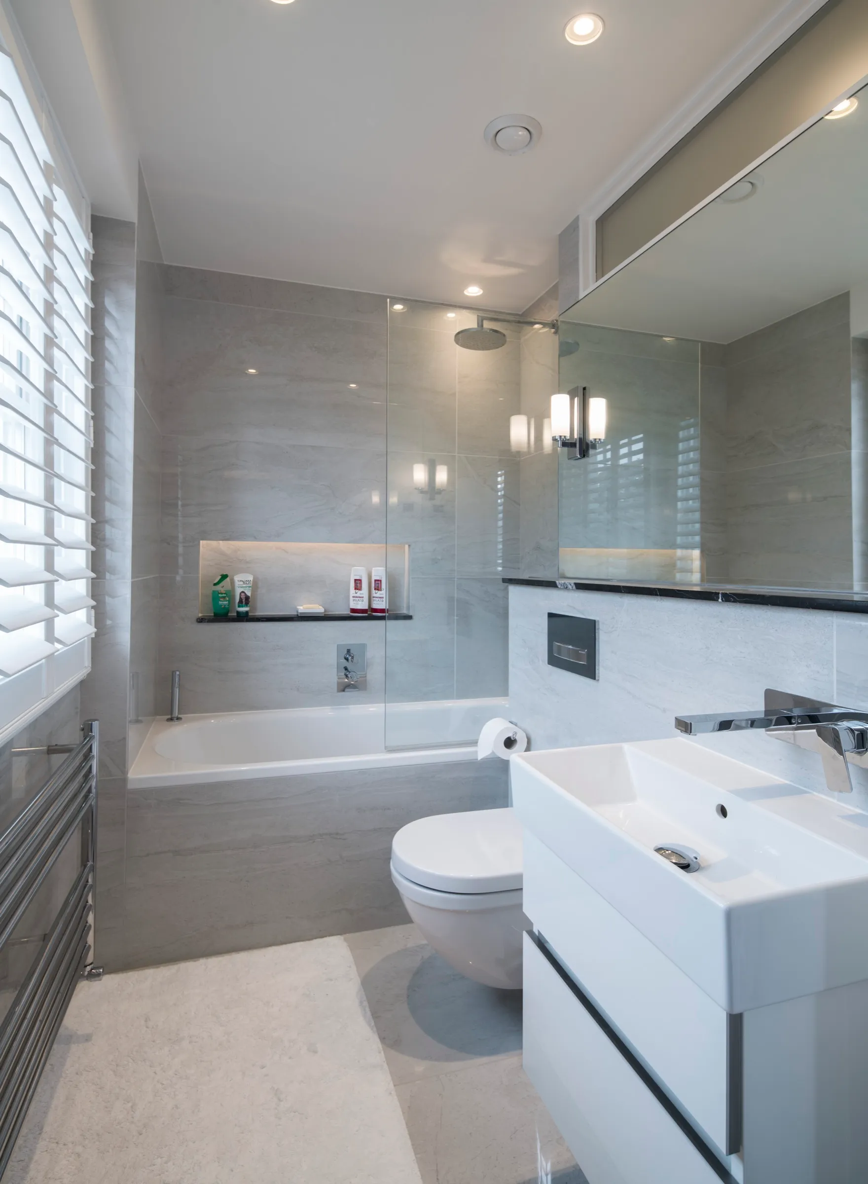 Bathroom with tiled bath surround and wall-hung basin