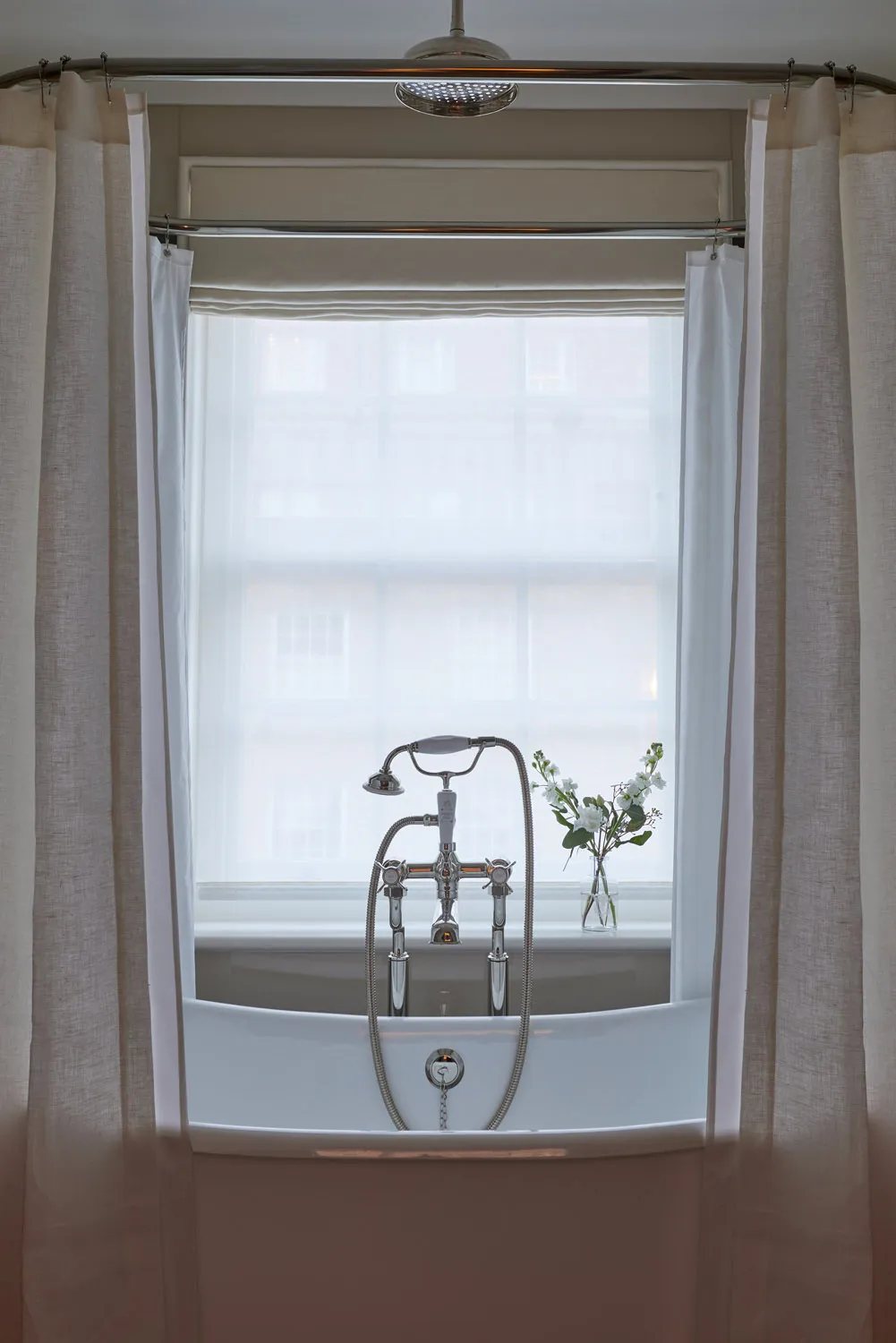 Bath set beneath a sash window