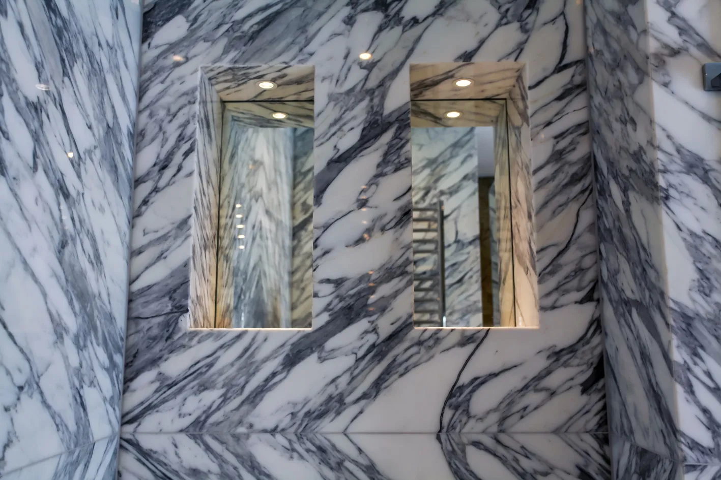 Arabescato marble bathroom with lit niches