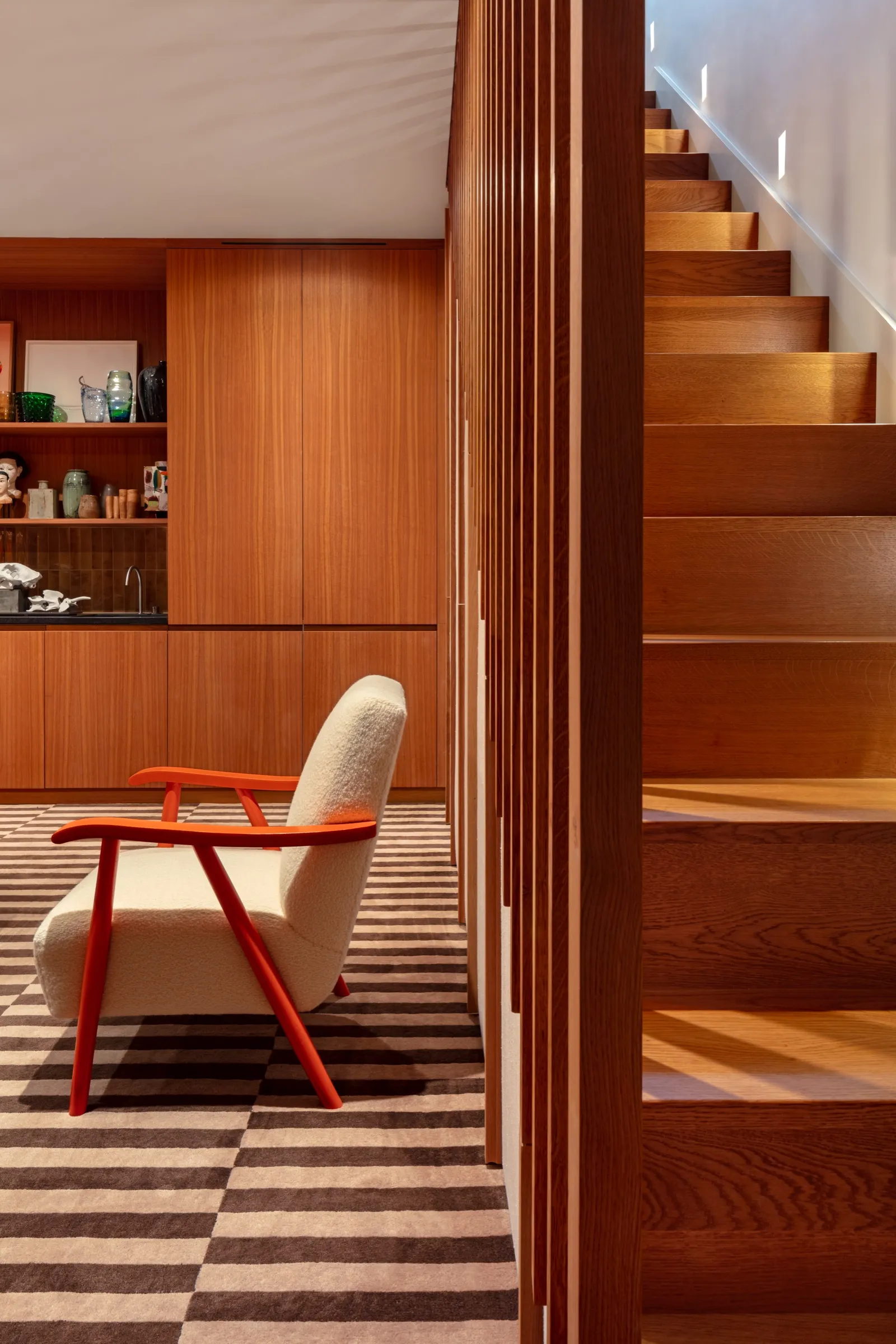 Timber staircase with slatted balustrade beside the living room