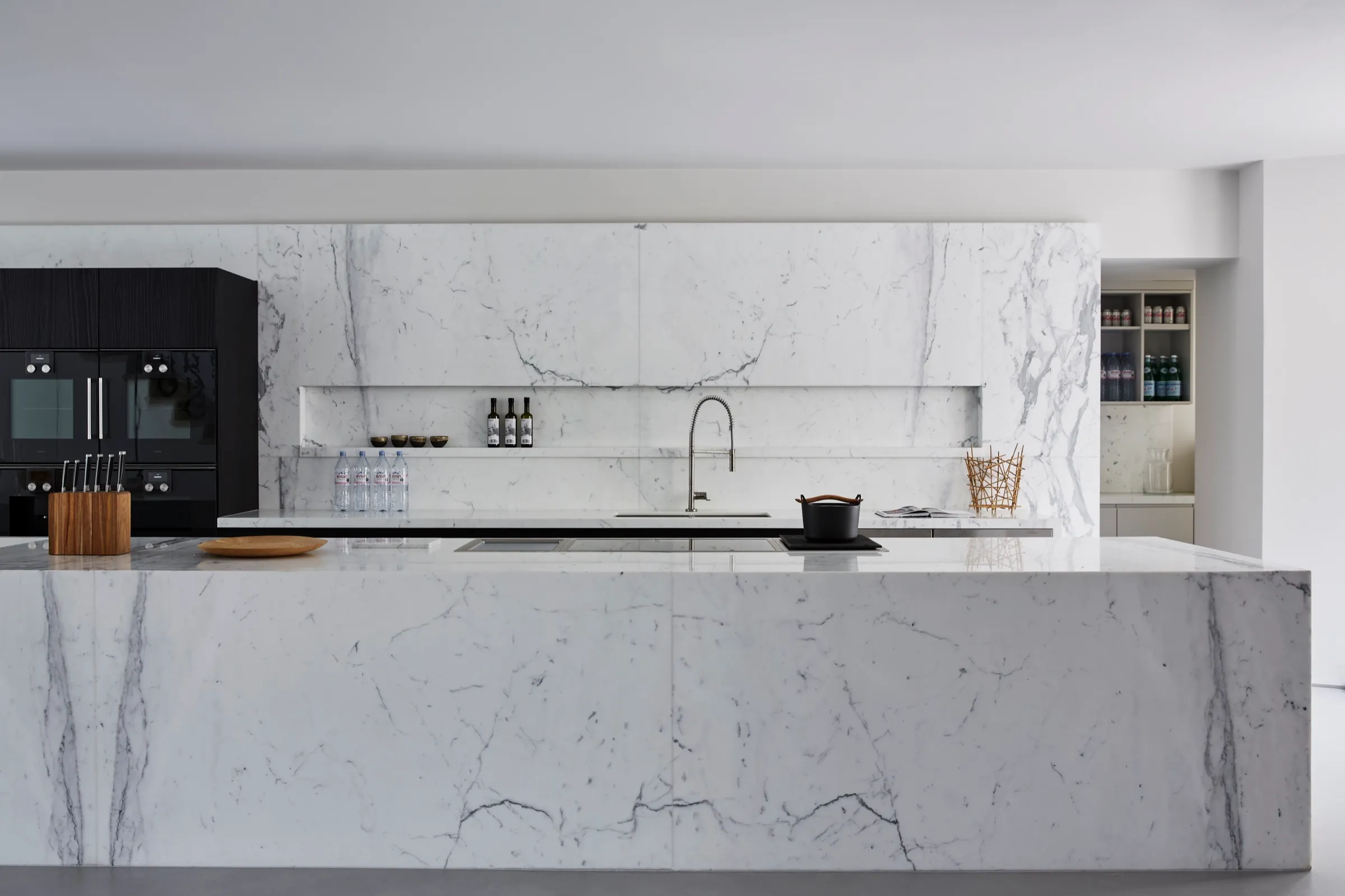 Kitchen with marble island and full-height marble splashback