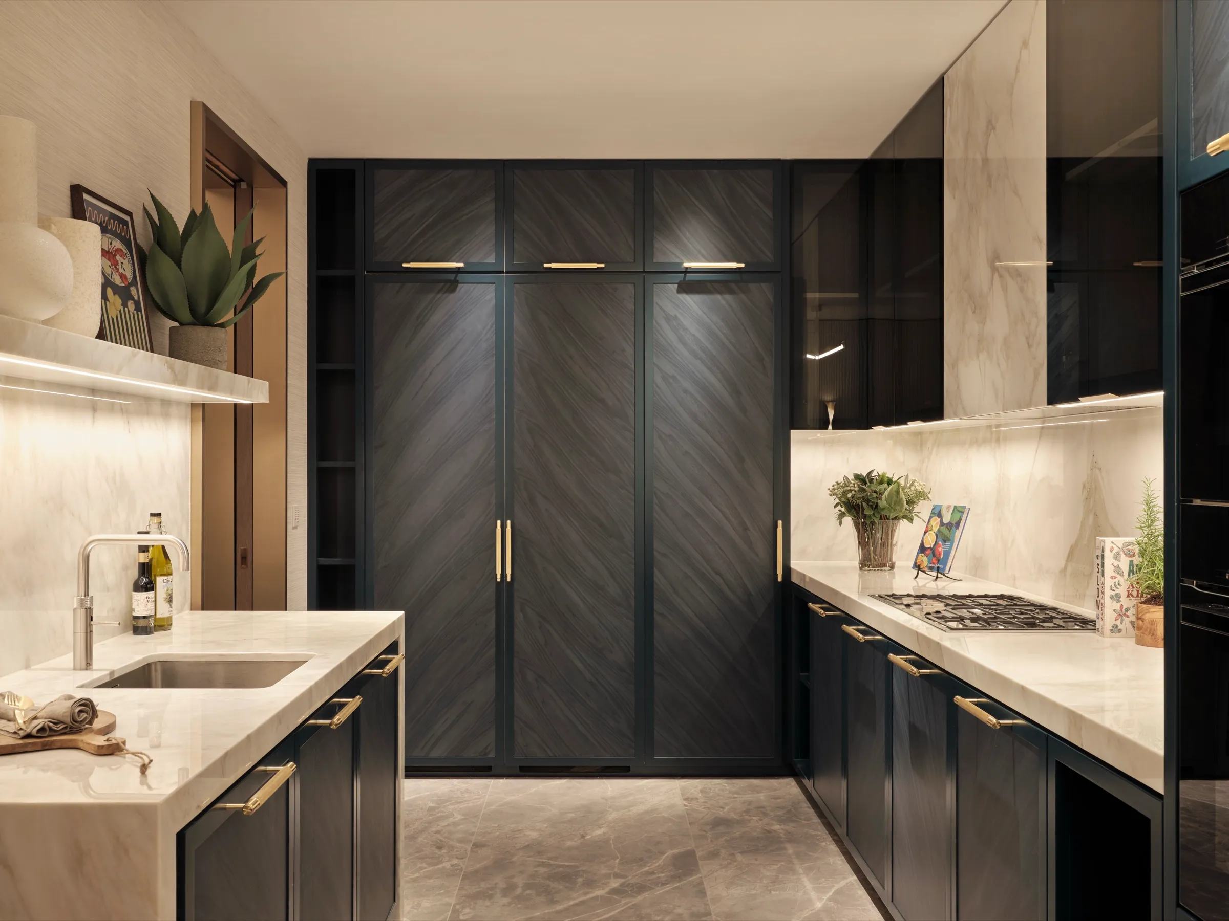 Kitchen with chevron-veneered dark cabinetry and marble worktops