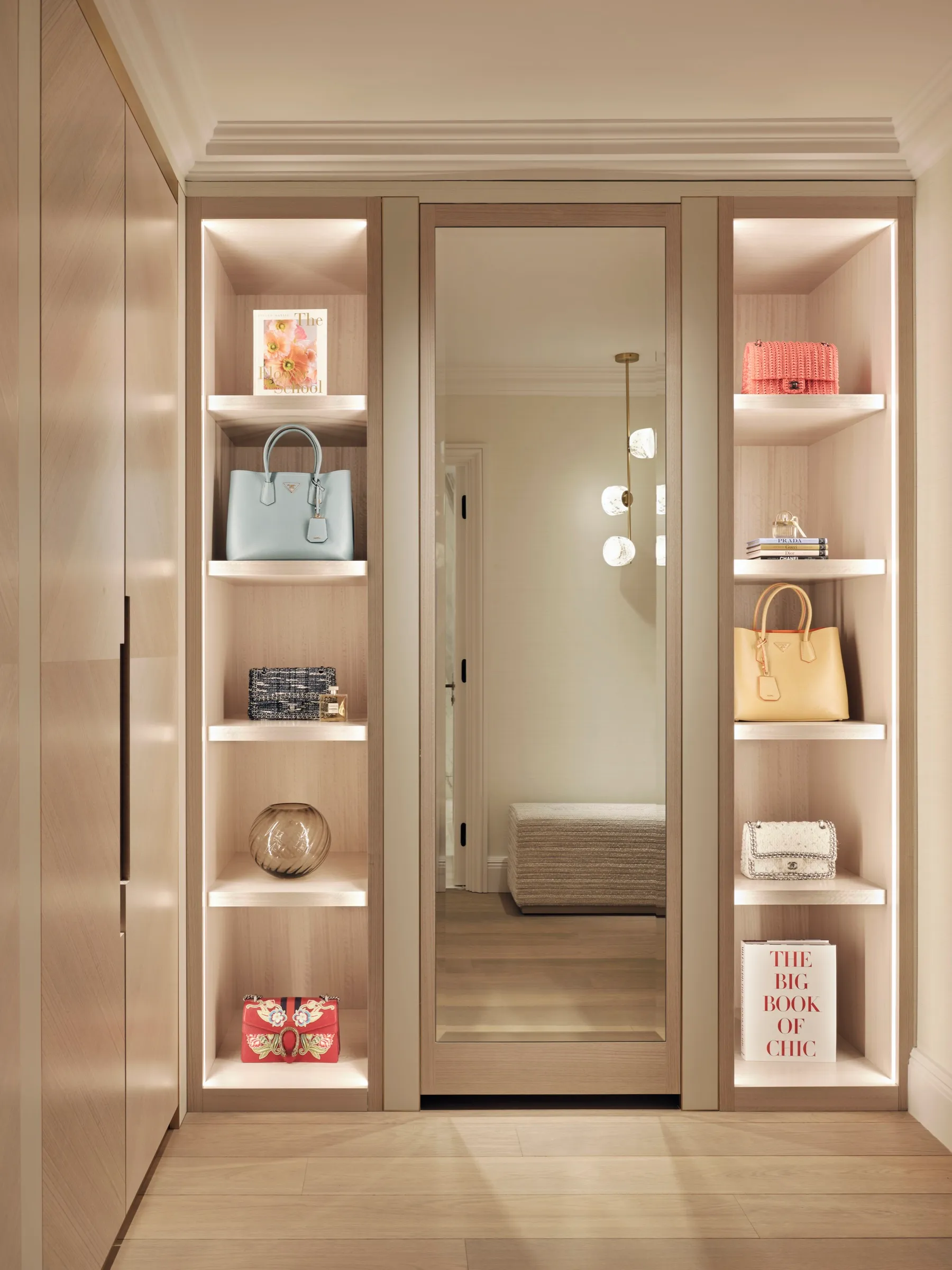Dressing room with lit shelving and mirrored door