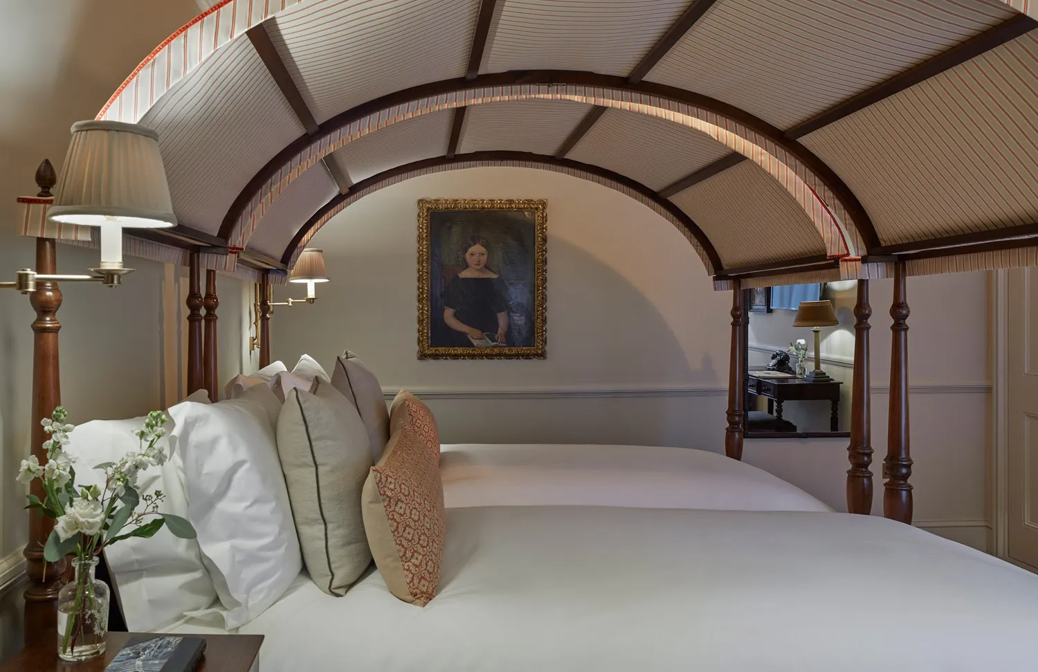 Bedroom with arched timber bed canopy