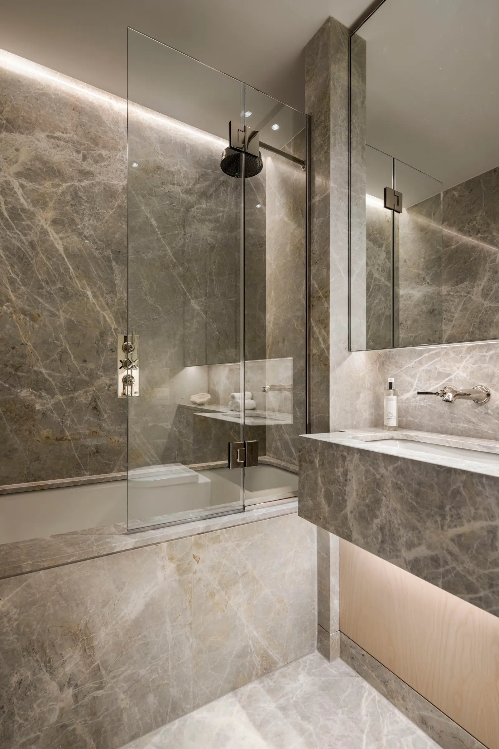 Grey marble bathroom with lit niche