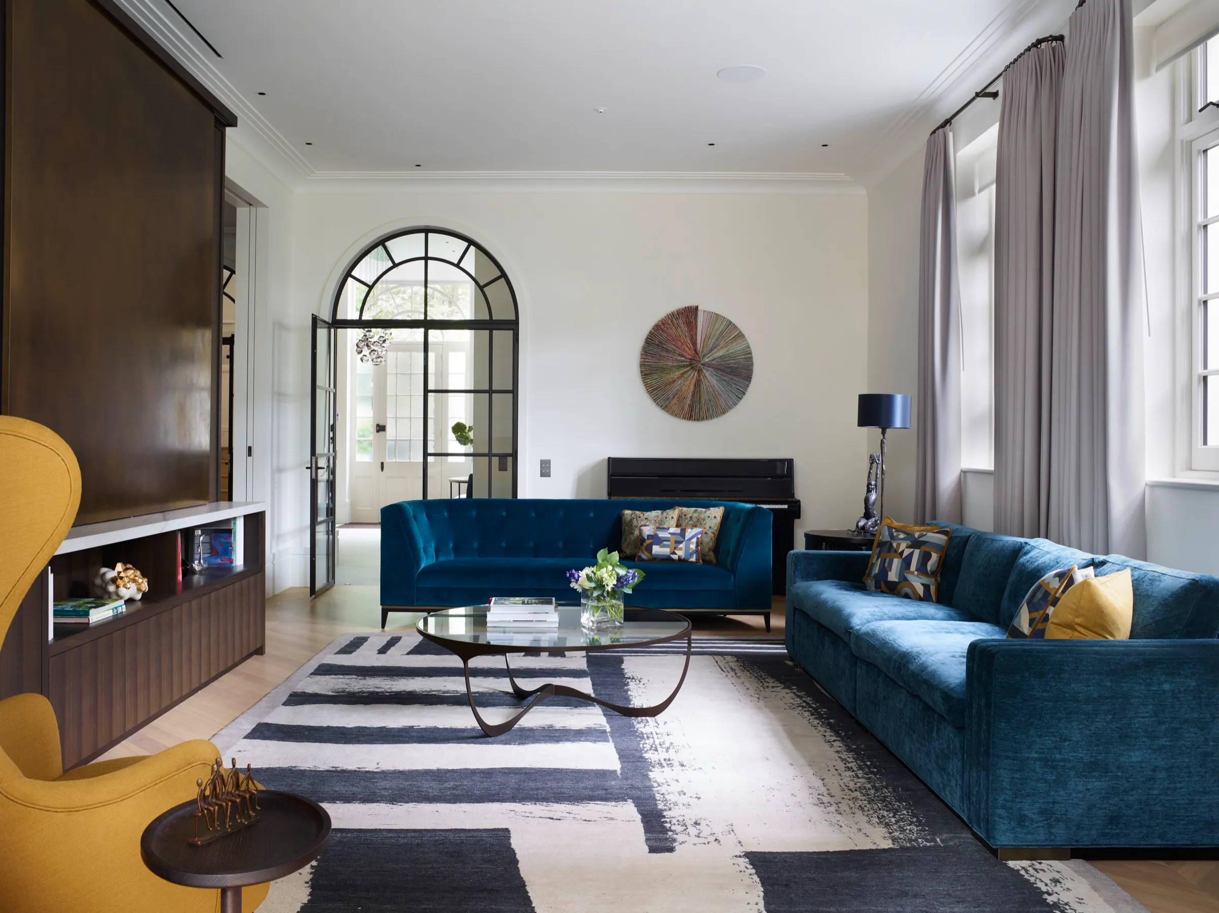 Living room with arched steel-framed garden doors