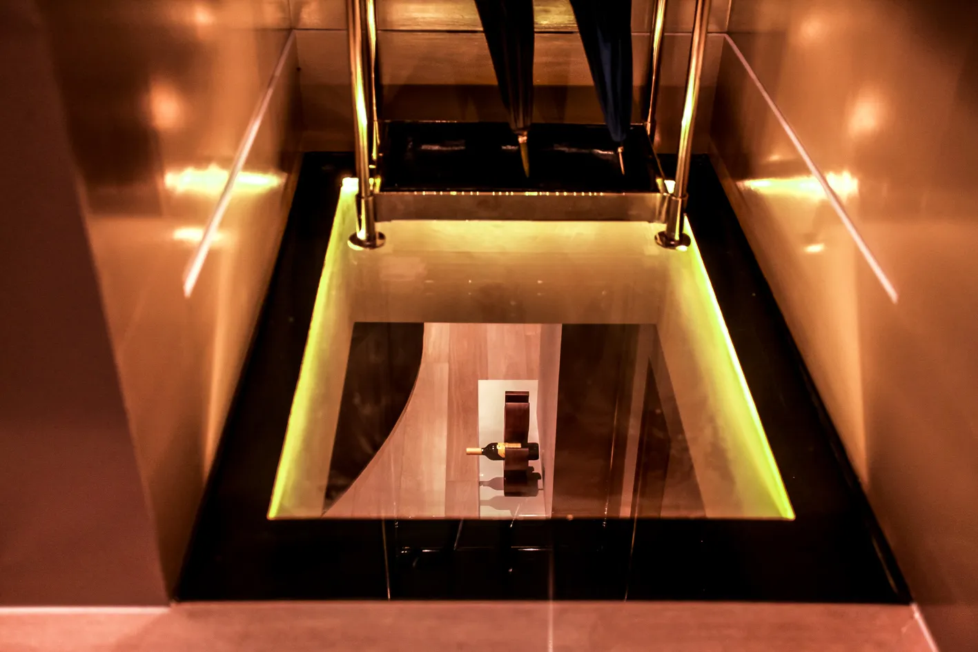 Glass floor panel lighting the basement