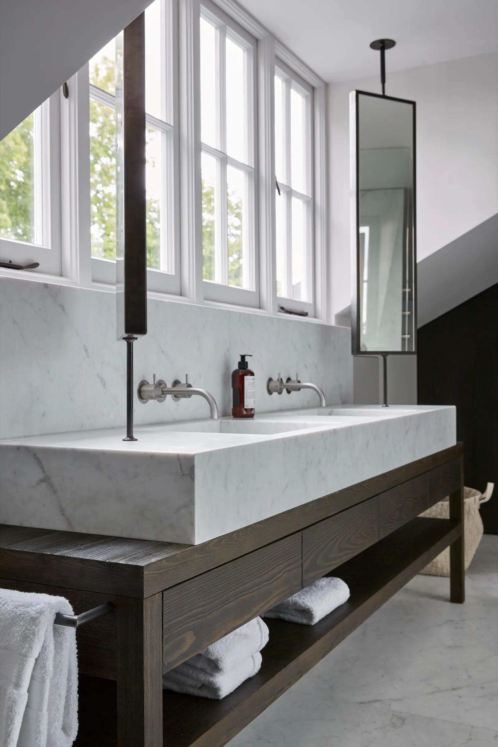 Marble trough basin on a dark timber vanity