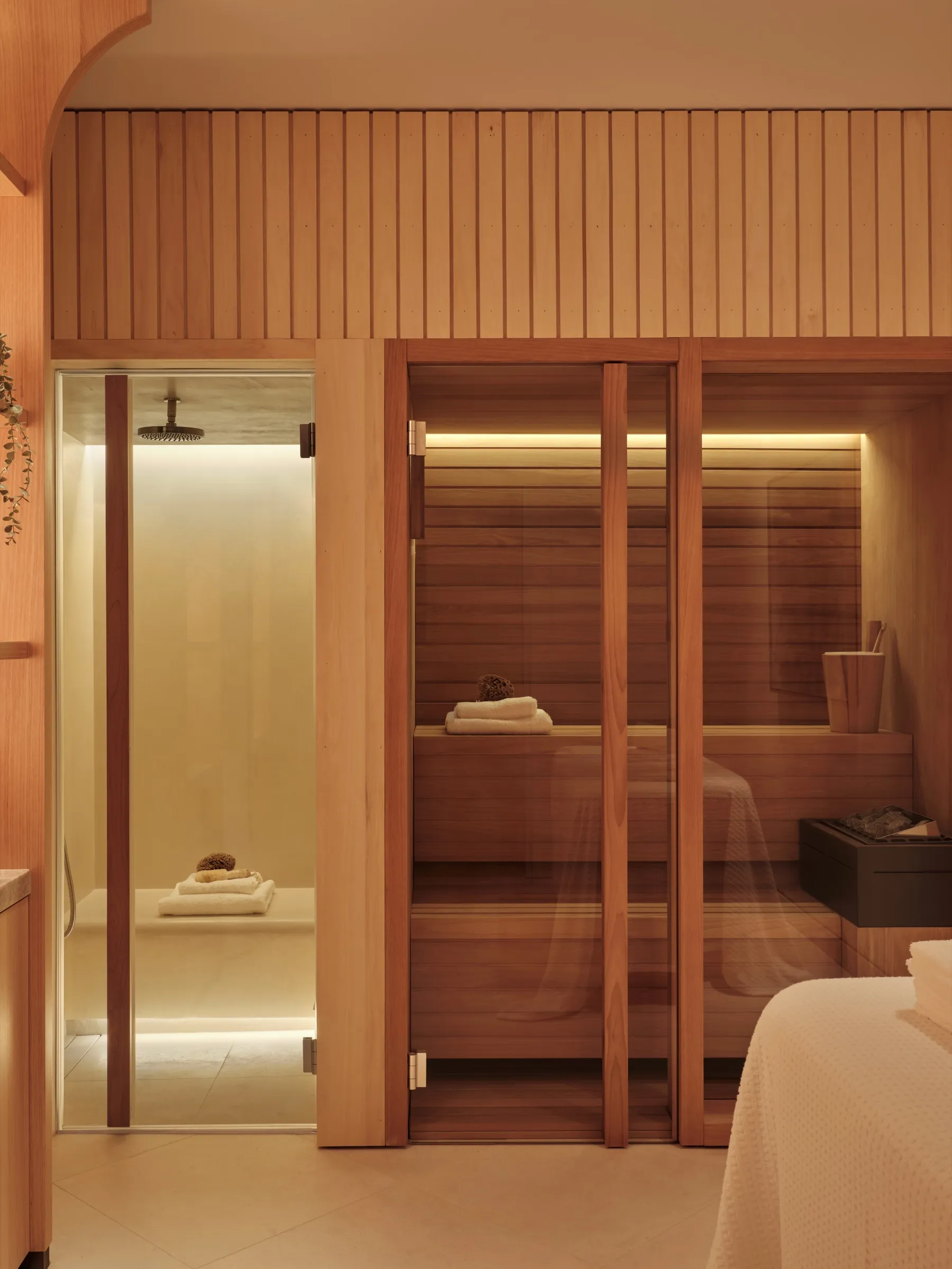 Sauna and steam room behind glazed doors